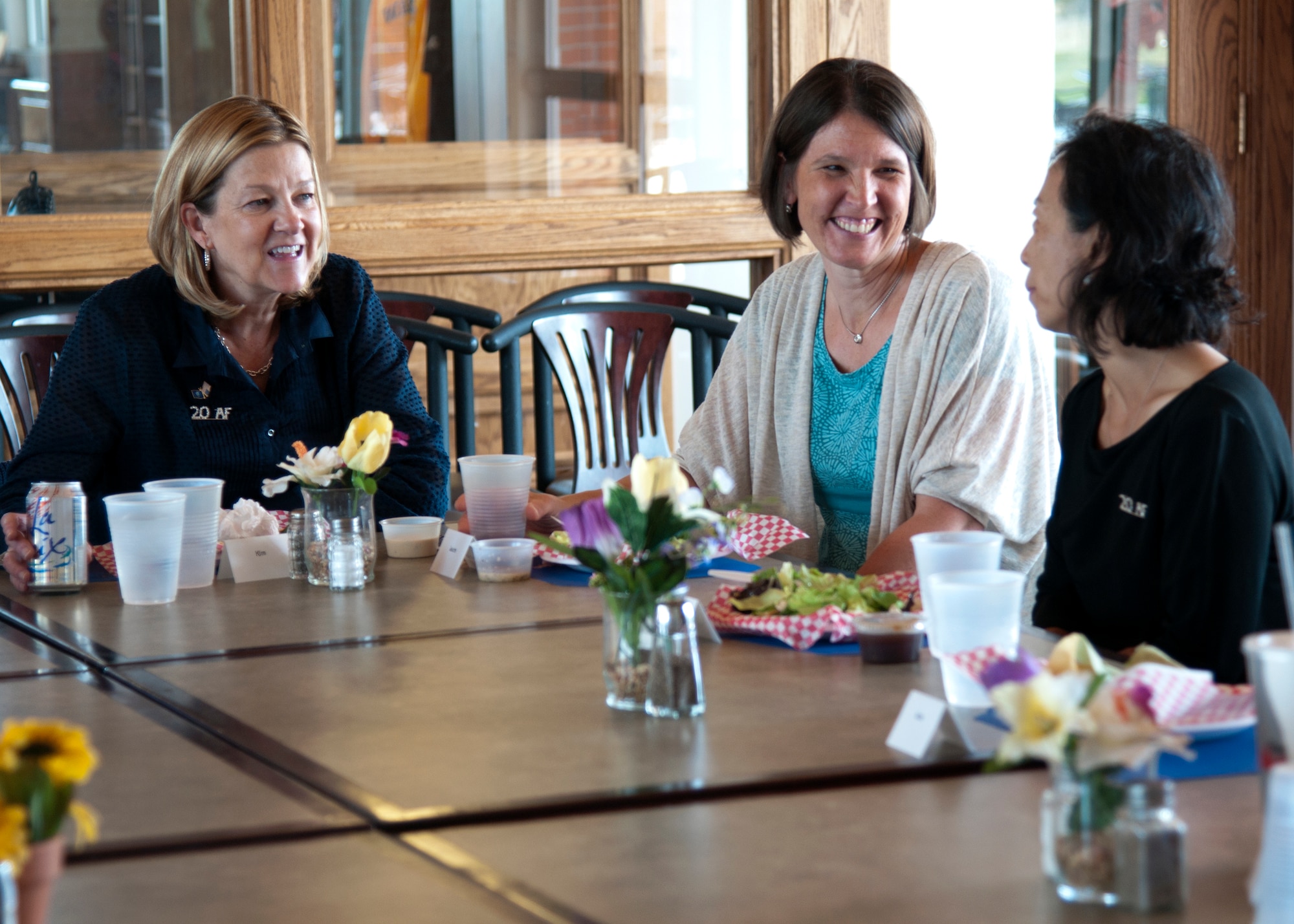 Kim Rand, left, wife of AFGSC commander Gen. Robin Rand, talks with Laura Megan-Posch and Kazumi Smith during a lunch with 20th Air Force spouses on F.E. Warren Air Force Base, Wyo., Sept. 22, 2015. While visiting, she met with spouses to gain families’ perspectives of the base. (U.S. Air Force photo by Airman 1st Class Malcolm Mayfield)