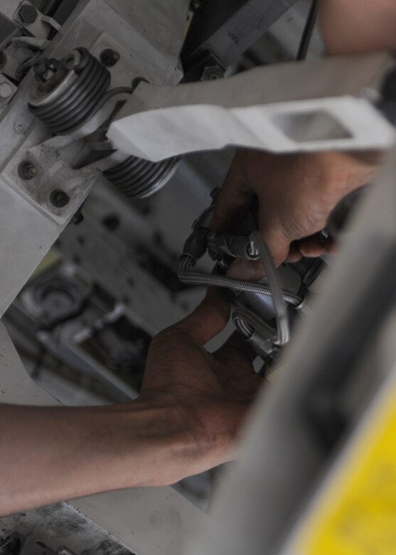 Airman 1st Class Bryan Bernhold, 28th Aircraft Maintenance Squadron weapons load crew member, decarts a B-1 bomber during the downloading process at Ellsworth Air Force Base, S.D., Sept. 21, 2015.Trained munitions personnel support 27 B-1 bombers with conventional munitions and armament systems, enabling global deterrence, precision strike and reconnaissance capabilities for the fleet. (U.S. Air Force photo by Airman Sadie Colbert/Released)