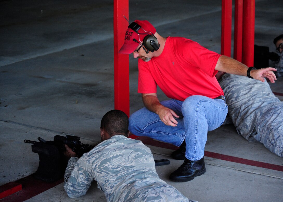 Kenneth Goree, 325 Security Forces Squadron combat arms instructor, assists Airman with proper firing and clearing techniques Sept. 14 at the combat arms firing range. The training and resources flight is responsible for training, armory functions, combat arms and unit supply. The training section is tasked with training all assigned security forces, augmentees and all base personnel slated for Air Expeditionary Force deployment. The armory stores government firearms and munitions used by security forces and other on-base units. This section also supports courtesy storage of weapons and munitions for residents in the dorms and base housing. The combat arms shop operates the base's firing range and conducts classroom and live weapons training for all personnel assigned to Tyndall. (U.S. Air Force photo by Airman 1st Class Solomon Cook/Released)