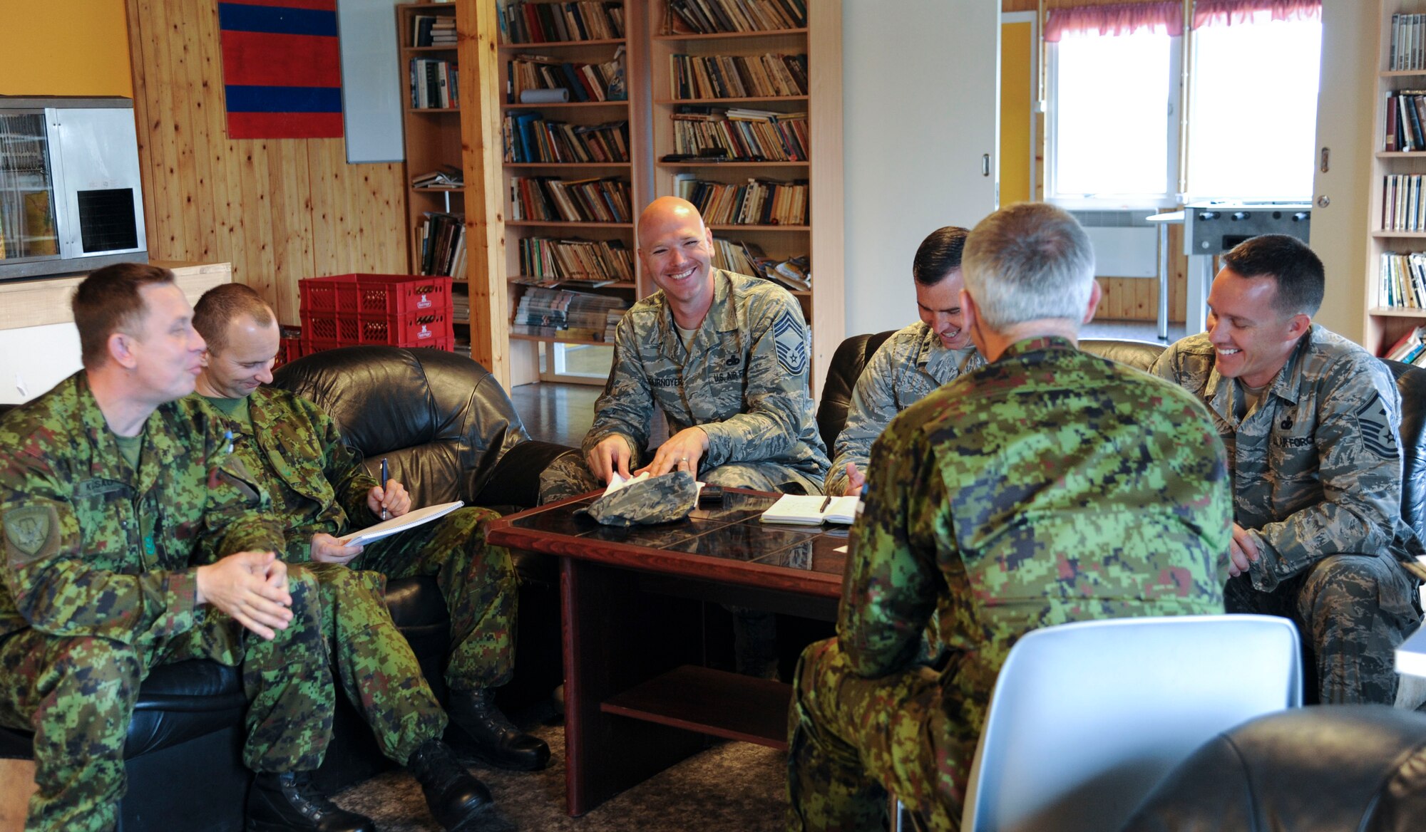 U.S. Air Force and Estonian air force leadership exchange ideas during a morale and welfare meeting at Amari Air Base, Estonia, Sept 28, 2015. Every week, leadership meet to exchange ideas, schedule morale events and discuss opportunities for community service projects.  (U.S. Air Force photo by Andrea Jenkins/Released)