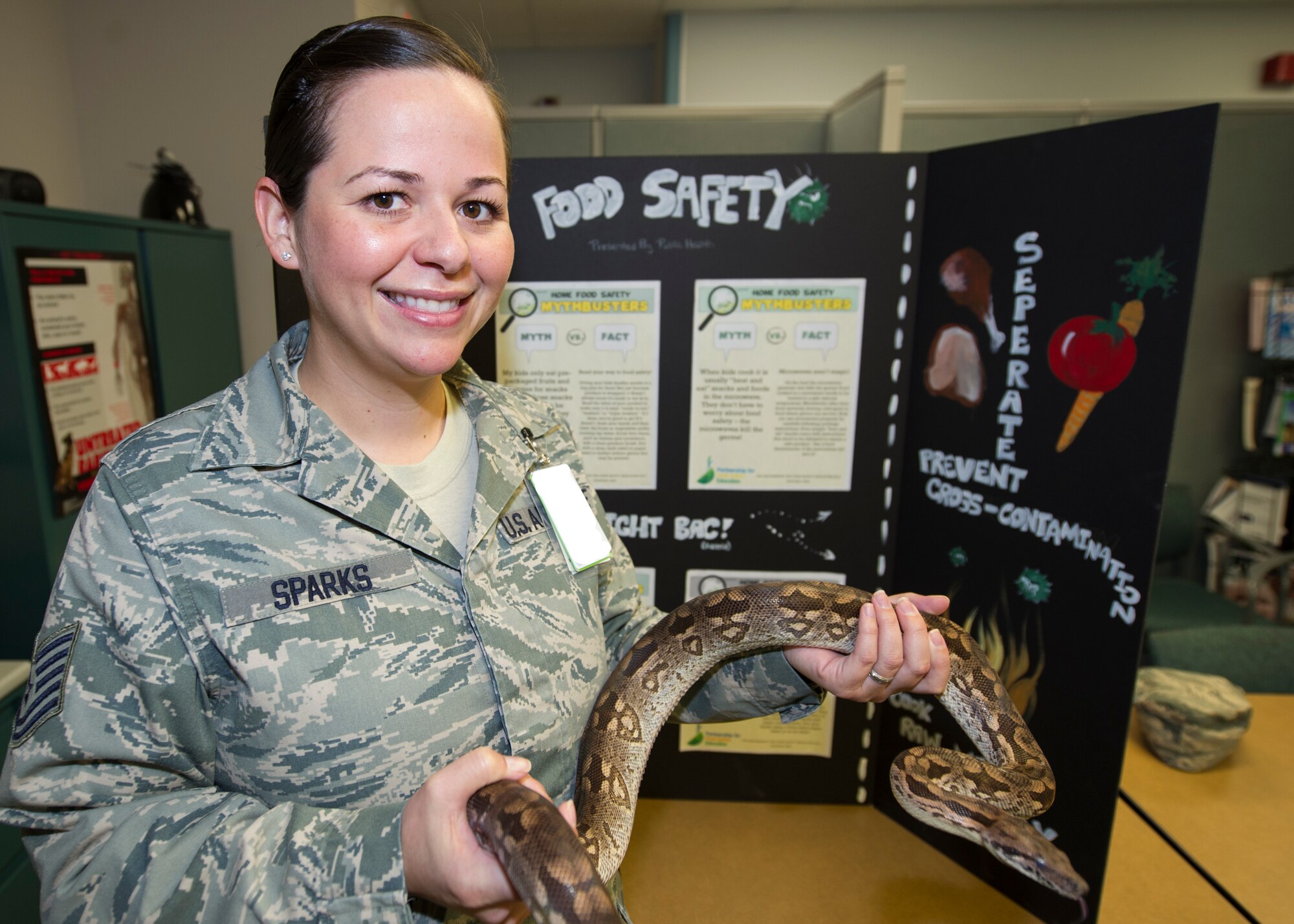 Technical Sgt. Melissa Sparks, the 49th Medical Group Public Health flight chief, poses for a photo with Mr. Snake, the public health mascot, at Holloman Air Force Base, N.M. Sparks was recognized as a superior performer during the Unit Effectiveness Inspection on Aug. 24-28. Members of Air Combat Command’s Inspector General team came to Holloman to ensure all units under the 49th Wing were in compliance with the commander’s inspection program. (U.S. Air Force photo by Airman 1st Class Emily A. Kenney)