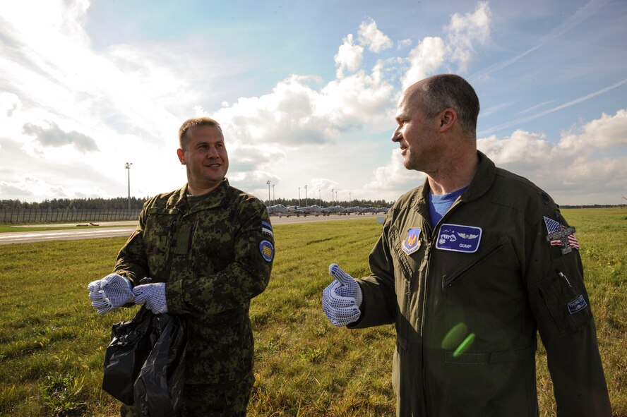 U.S. Air Force Lt. Col. Bryan France, 74th Expeditionary Fighter Squadron commander (right), and Estonian air force Chief of Staff Lt. Col. Riivo Valge share stories while participating in a foreign object debris walk of the flight line at Amari Air Base, Estonia, Sept. 25, 2015. The 74th EFS, deployed as part of a Theater Security Package, participated in the Estonian air force’s quarterly FOD walk. (U.S. Air Force photo by Andrea Jenkins/Released)