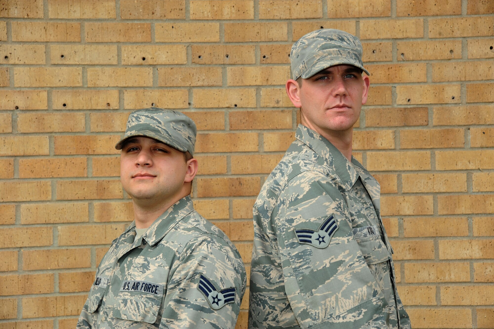 Senior Airmen Marquis Mello and Thomas Koch, 22nd Communications Squadron network administrators, pose for a photo Sept. 24, 2015, at McConnell Air Force Base, Kan. These Airmen are operation managers of Operation Cyber Shooter, a security programs that sends and tracks fake phishing emails within units in order to study cyber trends. (U.S. Air Force Photo by Airman Jenna K. Caldwell)