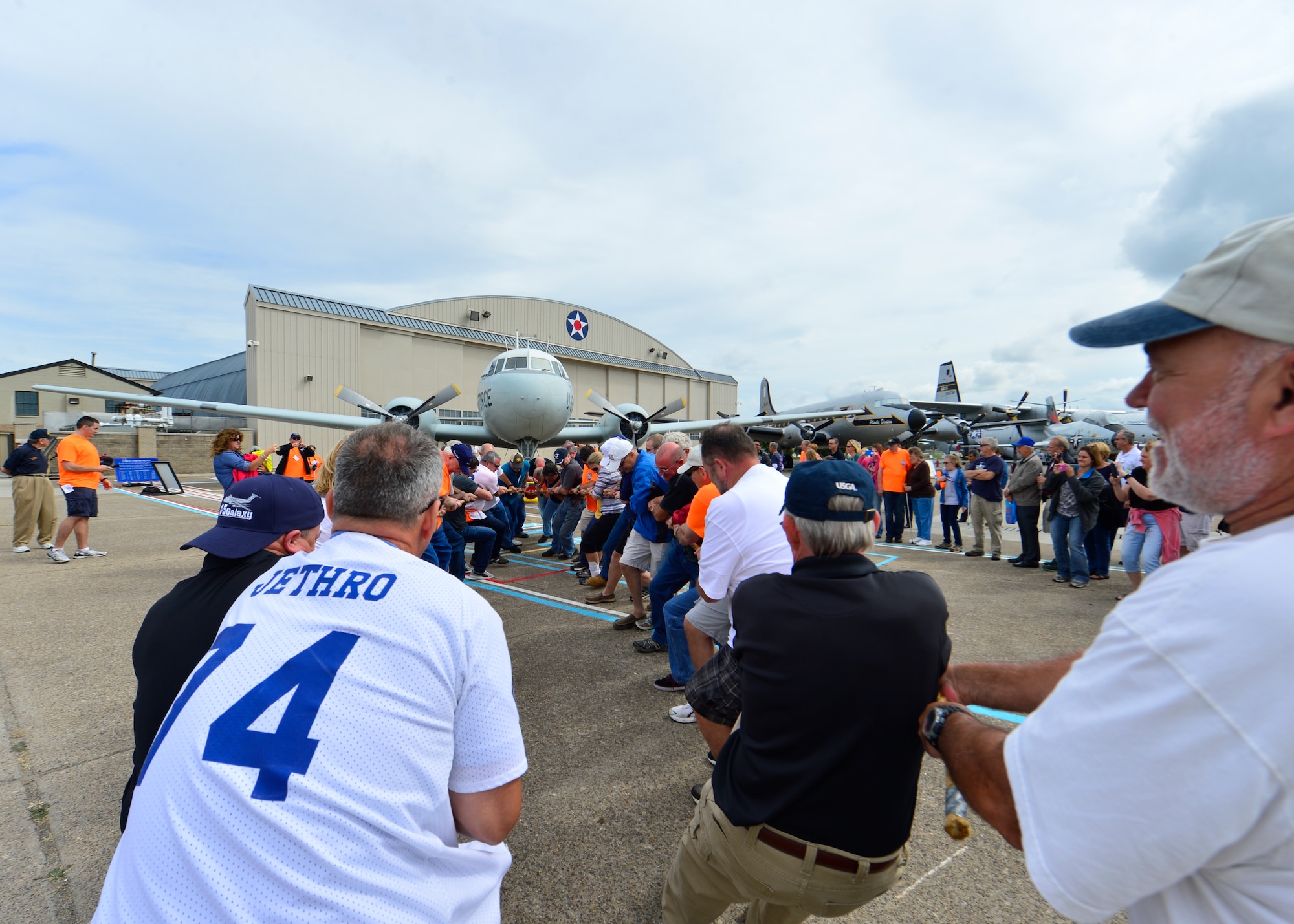 Current and former loadmasters from the 9th Airlift Squadron pull a C-131 Samaritan during the Plane Pull event of the 9th AS 75th Anniversary Reunion Sept. 26, 2015, at The Air Mobility Command Museum on Dover Air Force Base, Del. Loadmasters, pilots, and flight engineers competed as groups to see who could pull the plane a set distance the fastest. The loadmasters and flight engineers tied for first place. (U.S. Air Force photo/Senior Airman William Johnson) 