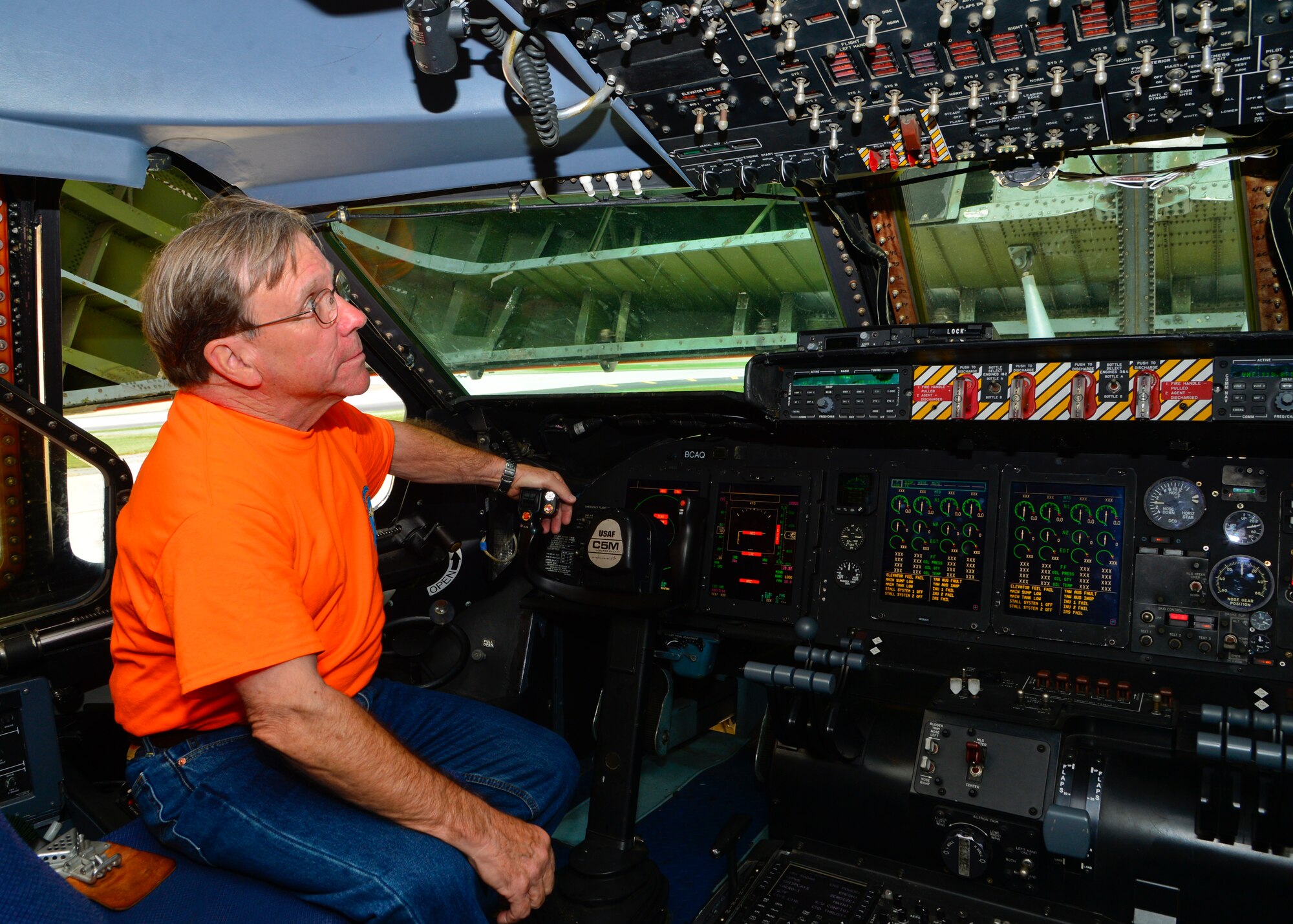 Lt. Col. Mike Phillips (Ret.) looks at the inside of the cockpit of a C-5M Super Galaxy during the 9th Airlift Squadron 75th Anniversary Reunion Sept. 26, 2015, at Dover Air Force Base, Del. Phillips is a former C-5 pilot and was assigned to the 9th AS from 1979-1982 and 1985-1989. (U.S. Air Force photo/Senior Airman William Johnson)