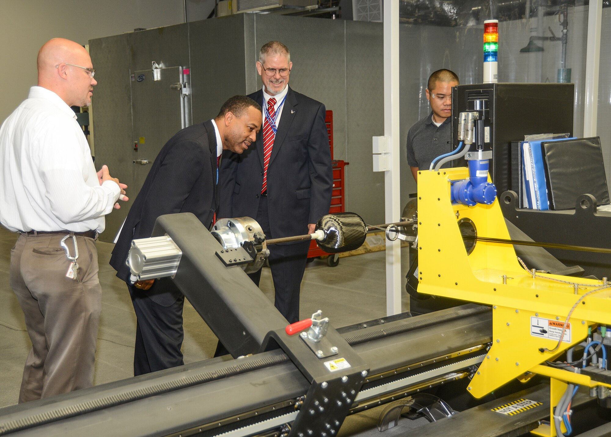 Left to right: Dr. Greg Yandek, shows Joe Gordon and Dr. David Walker, a filament winder for composite rocket motor cases. Walker is a senior executive for the Air Force and is responsible for preparing policy, guidance and advocacy for the Air Force's annual
$2 billion science and technology program. (U.S. Air Force photo by Kenji Thuloweit)
