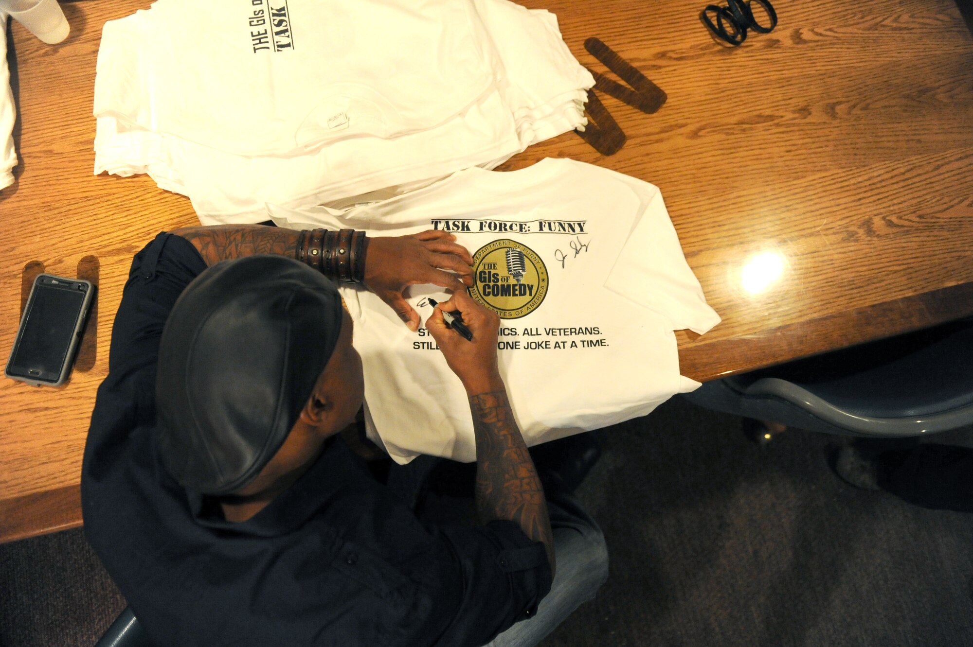 Eljaye Montengro signs autographs at the Jimmy Doolittle Center at Minot Air Force Base, N.D. Sept. 26, 2015. Montenegro is part of the GIs of Comedy who travel to different bases and locations all over the world to perform for troops. (U.S. Air Force photo by Staff Sgt. Chad Trujillo)