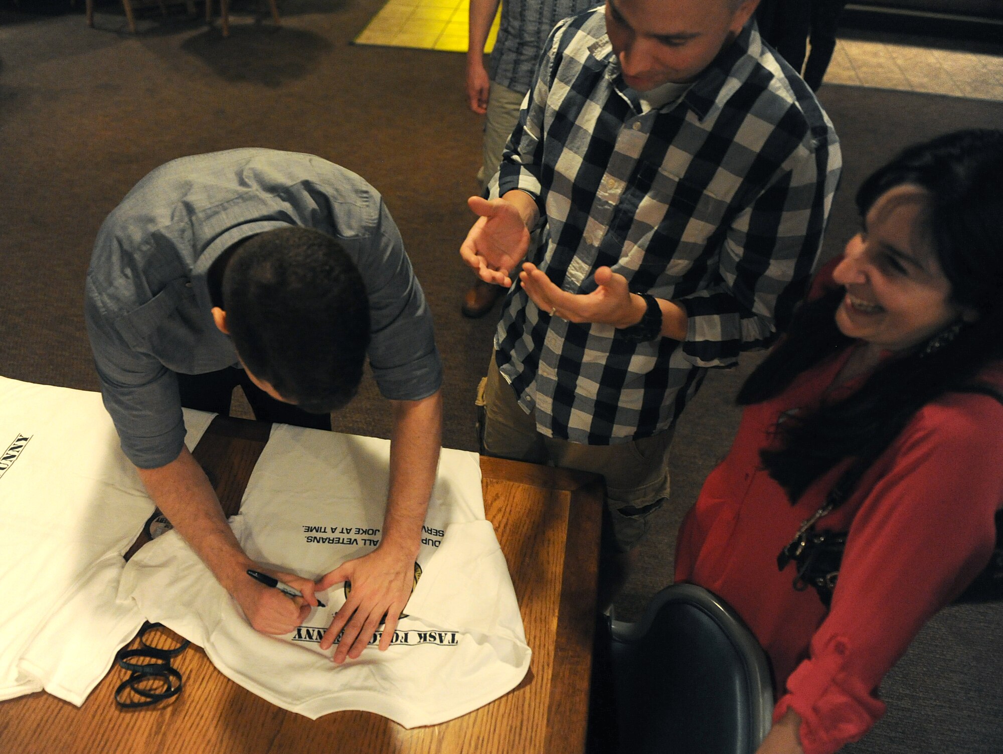 Jose Sarduy signs autographs at the Jimmy Doolittle Center at Minot Air Force Base, N.D. Sept. 26, 2015. Sarduy is part of the GIs of Comedy who travel to different bases and locations all over the world to perform for troops. (U.S. Air Force photo by Staff Sgt. Chad Trujillo) 