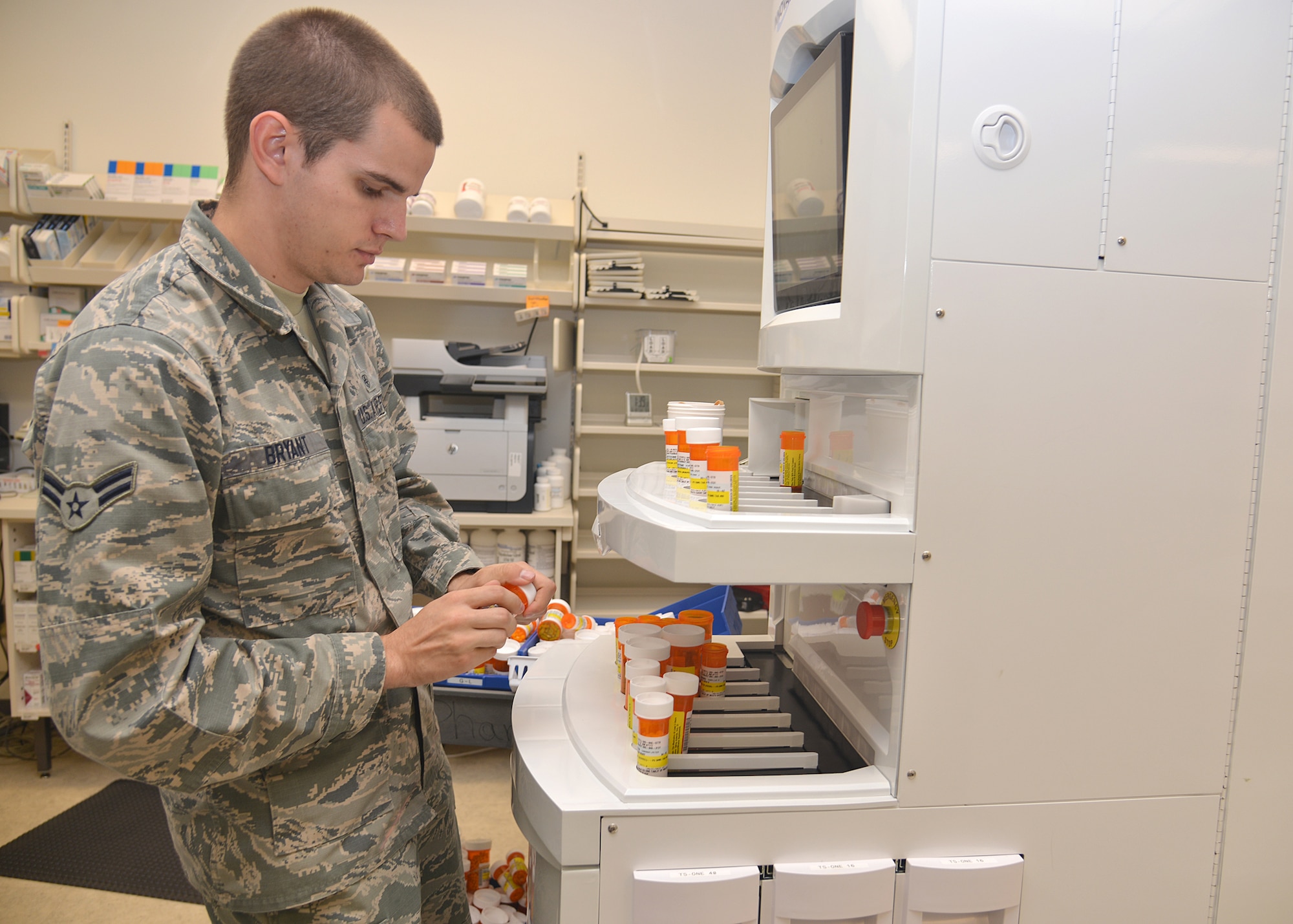 Airman 1st Class Joseph Bryant, 377th Medical Support Squadron, checks prescriptions processed by the robotic automation system. The system is used at the new pharmacy location at the Base Exchange, which opens Oct. 26. (Photo by Todd Berenger)