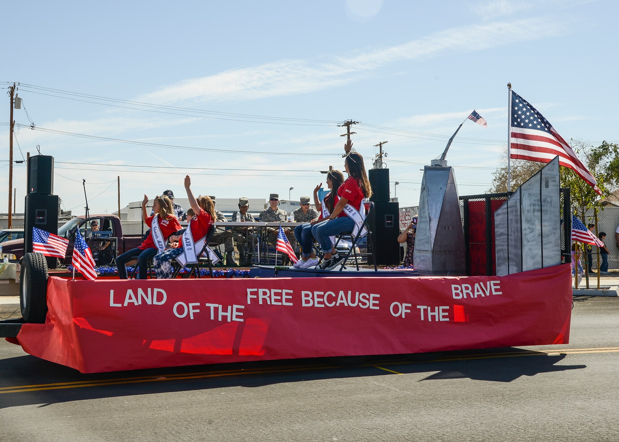 The Edwards AFB 2015 Community Queens passes the judges table in a float that read, “Land of the free, because of the brave.” (U.S. Air Force photo by Rebecca Amber)
