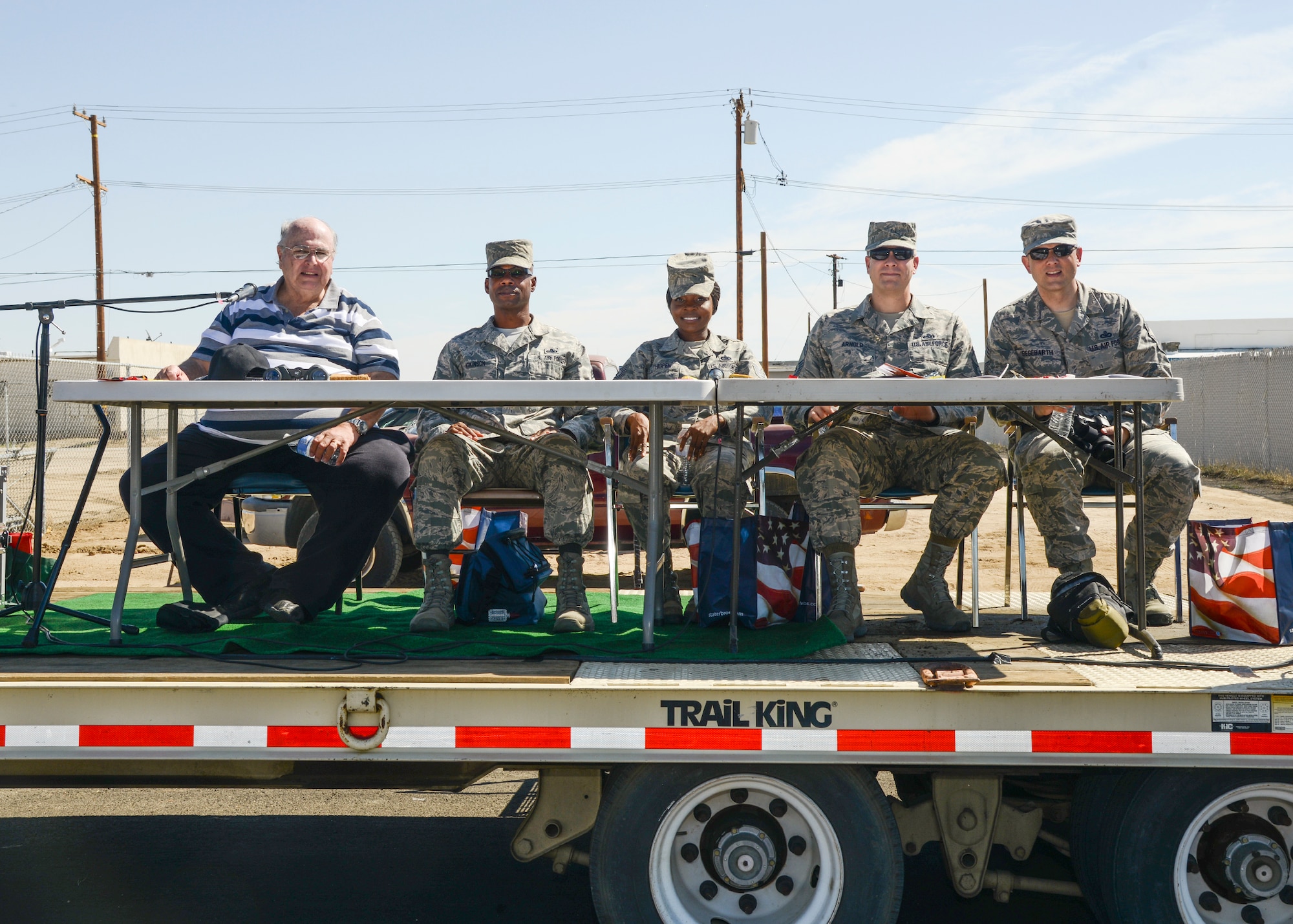 Dennis Shoffner (left) 412th Test Wing Public Affairs Community Relations chief, volunteered as announcer for the parade. With him (left to right), Chief Master Sgt. Carlos Atkinson, Tech. Sgt. Zenetra Thigpen, Chief Master Sgt. Kennon Arnold and Chief Master Sgt. James Segebarth served as judges for the parade. (U.S. Air Force photo by Rebecca Amber)
