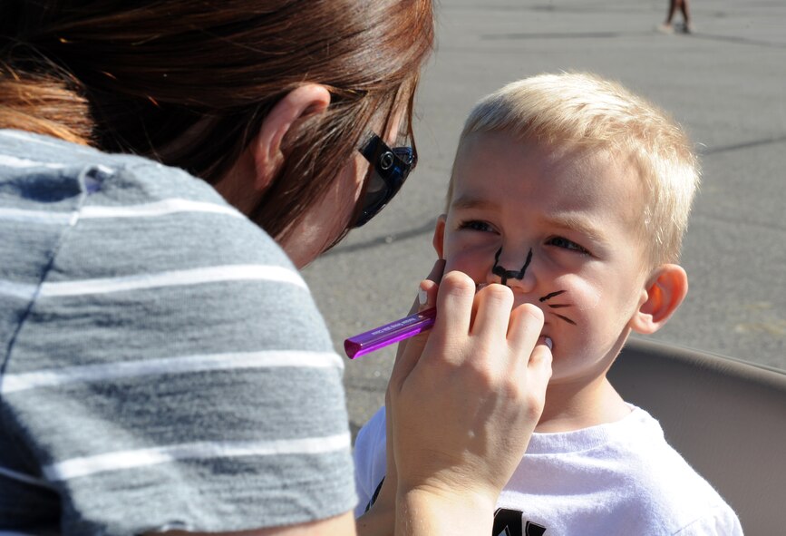Clay Jessup gets his face painted at the fall festival at Minot Air Force Base, N.D. Sept. 26, 2015. The fall festival was hosted by the 91st Missile Wing and had several different fundraising activities for Airmen and their families on the base. (U.S. Air Force photo by Staff Sgt. Chad Trujillo) 



