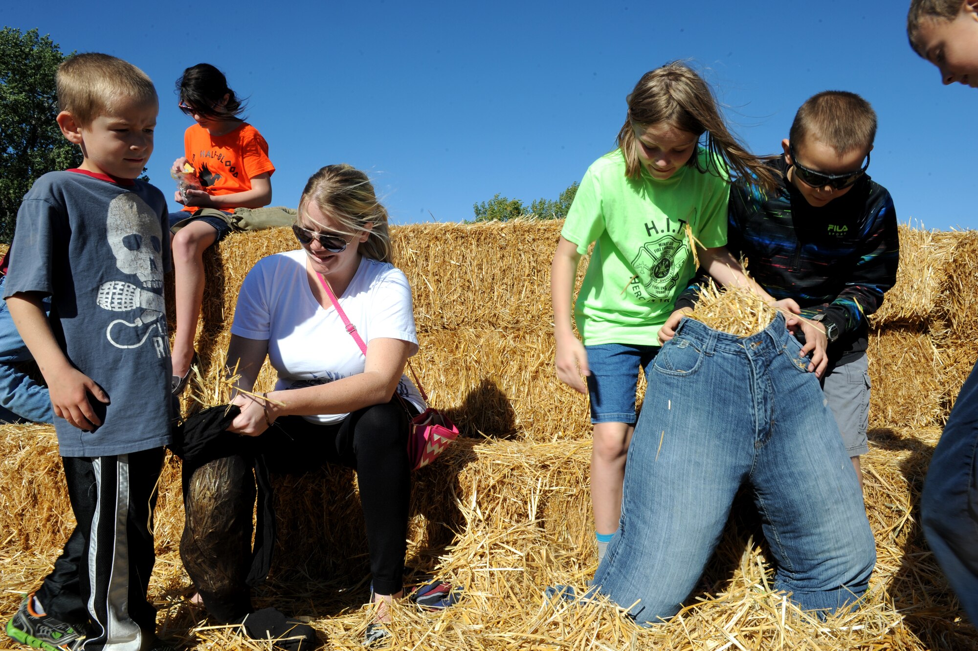 Airmen and their families build their own scarecrows at the fall festival at Minot Air Force Base, N.D. Sept. 26, 2015. The fall festival was hosted by the 91st Missile Wing and had several different fundraising activities for Airmen and their families on the base. (U.S. Air Force photo by Staff Sgt. Chad Trujillo) 



