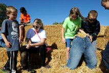Airmen and their families build their own scarecrows at the fall festival at Minot Air Force Base, N.D. Sept. 26, 2015. The fall festival was hosted by the 91st Missile Wing and had several different fundraising activities for Airmen and their families on the base. (U.S. Air Force photo by Staff Sgt. Chad Trujillo) 



