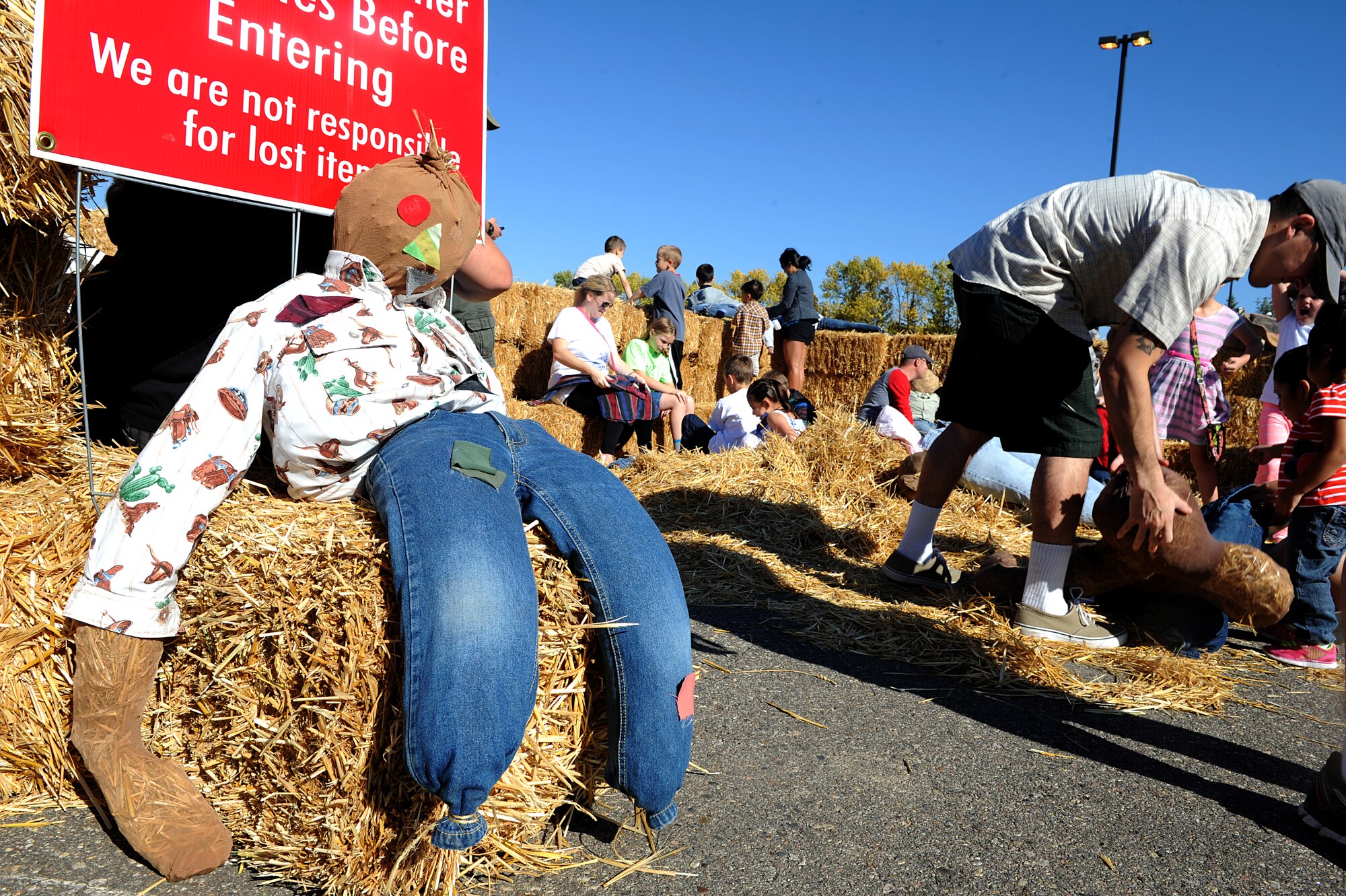 Airmen and their families build their own scarecrows at the fall festival at Minot Air Force Base, N.D. Sept. 26, 2015. The fall festival was hosted by the 91st Missile Wing and had several different fundraising activities for Airmen and their families on the base. (U.S. Air Force photo by Staff Sgt. Chad Trujillo) 

