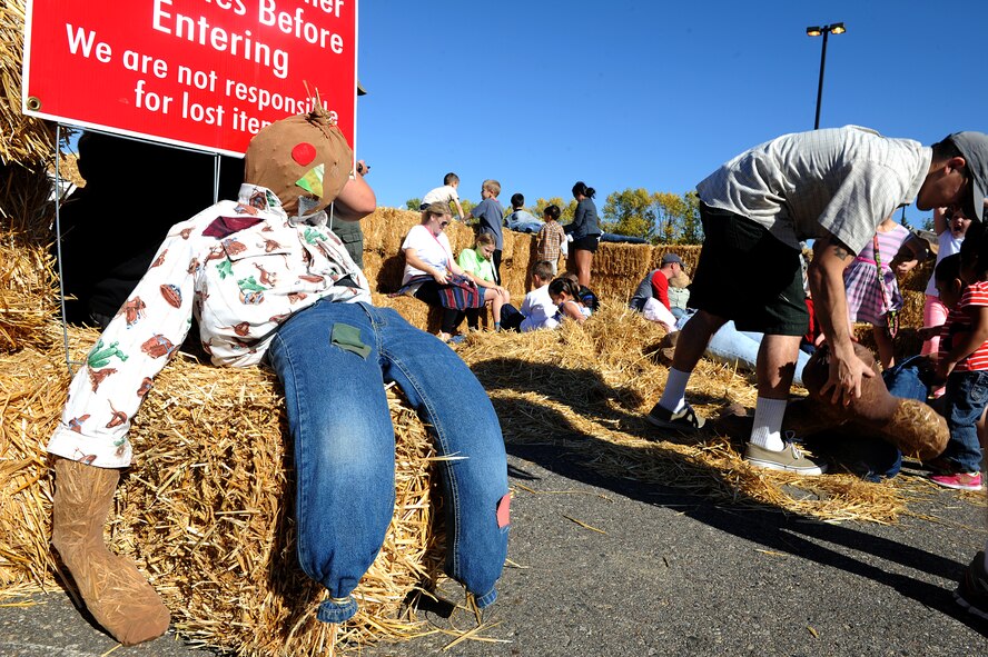 Airmen and their families build their own scarecrows at the fall festival at Minot Air Force Base, N.D. Sept. 26, 2015. The fall festival was hosted by the 91st Missile Wing and had several different fundraising activities for Airmen and their families on the base. (U.S. Air Force photo by Staff Sgt. Chad Trujillo) 

