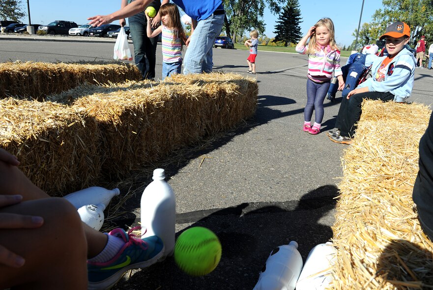 Qwynn Trujillo plays a bowling game at the fall festival at Minot Air Force Base, N.D. Sept. 26, 2015. The fall festival was hosted by the 91st Missile Wing and had several different fundraising activities for Airmen and their families on the base. (U.S. Air Force photo by Staff Sgt. Chad Trujillo) 