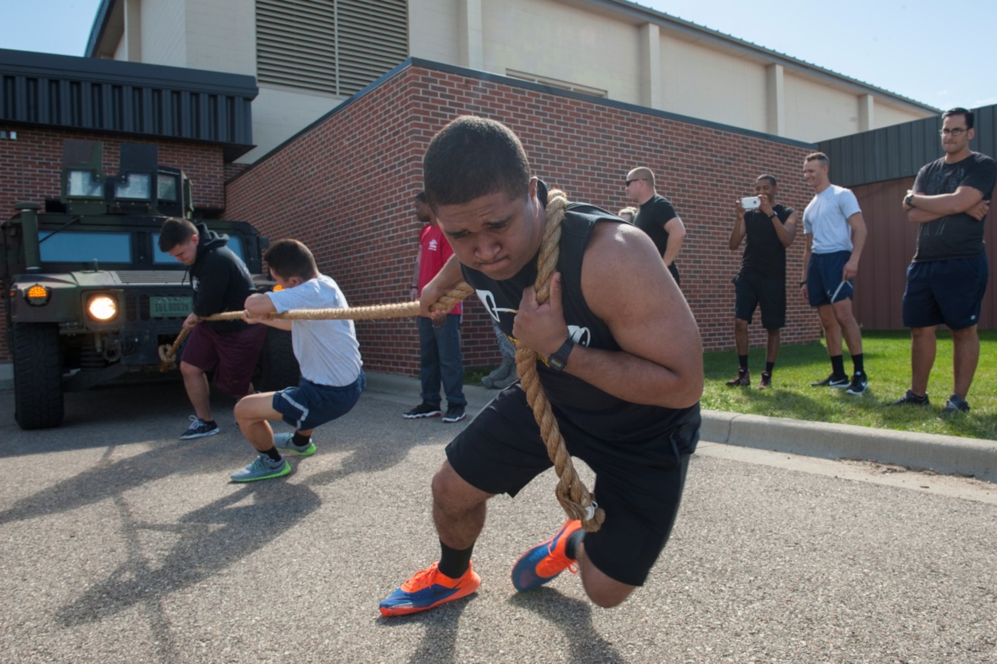 Minot Airmen pull a 7,500 pound Humvee during the team portion of the Humvee pull at Minot Air Force Base, N.D., Sep. 21, 2015. Sports day consisted of several team events throughout the day that helped promote wingmanship and team-building. (U.S. Air Force photo/Airman 1st Class Christian Sullivan)