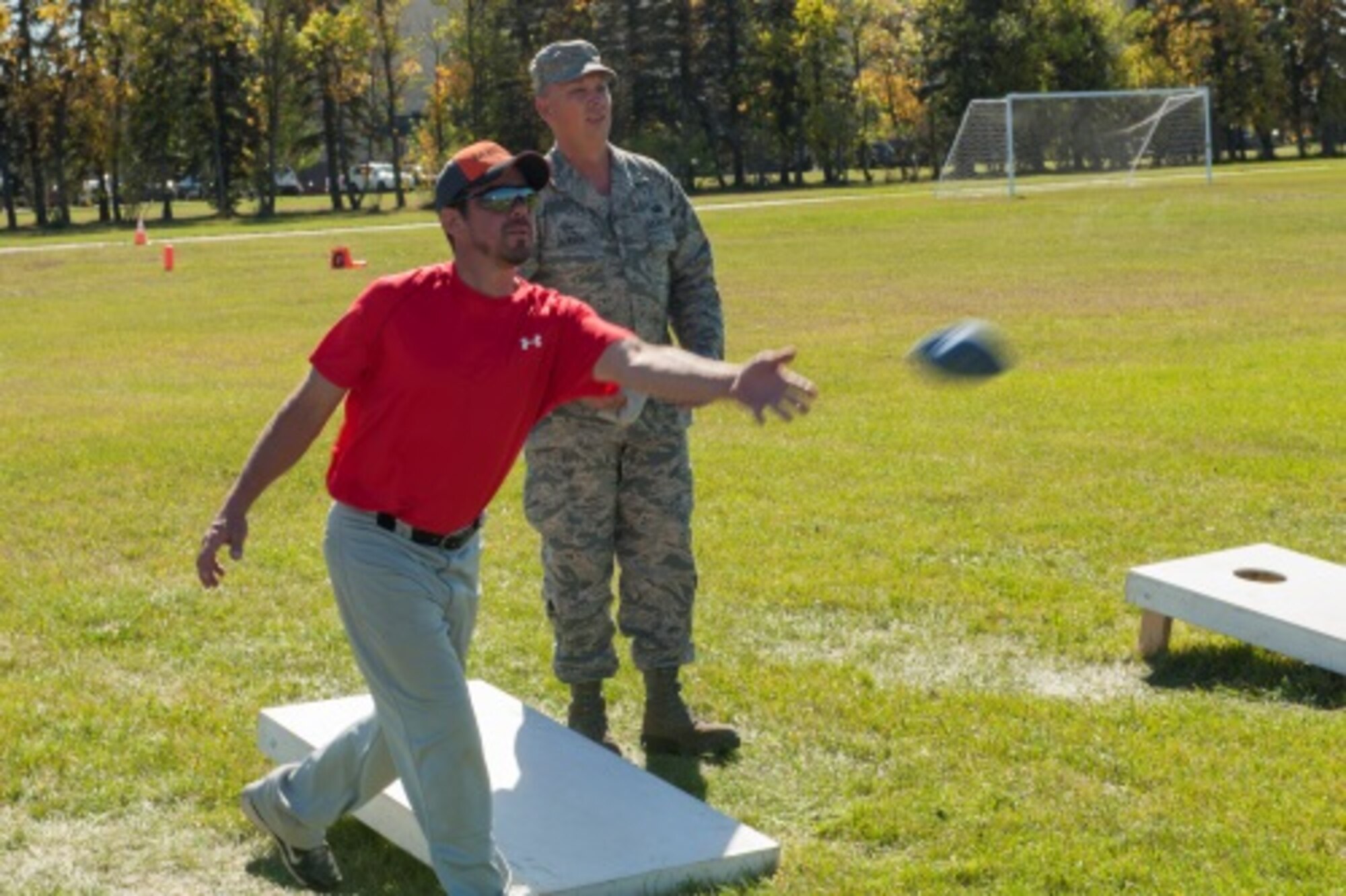A Minot member tosses a beanbag during a game of corn hole for sports day at Minot Air Force Base, N.D., Sep. 21, 2015. Sports day consisted of several team events throughout the day that helped promote wingmanship and team-building. (U.S. Air Force photo/Airman 1st Class Christian Sullivan)