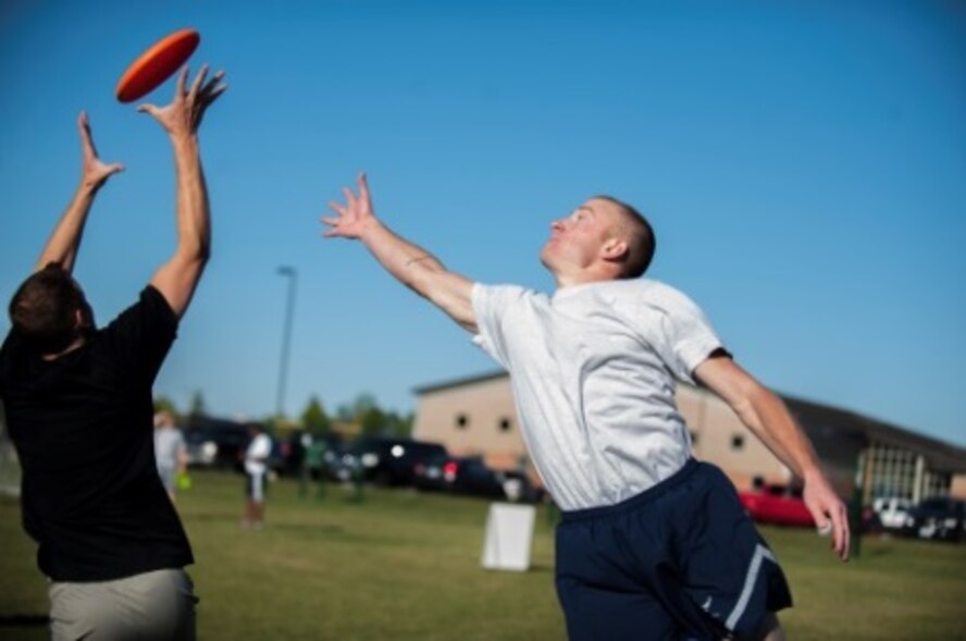 Two Minot Airmen attempt to catch a Frisbee during sports day at Minot Air Force Base, N.D., Sep. 21, 2015. Sports day was held in honor of Wingman Week, which is a week set aside for shops to come together and work as a team. (U.S. Air Force photo/Airman 1st Class Christian Sullivan)