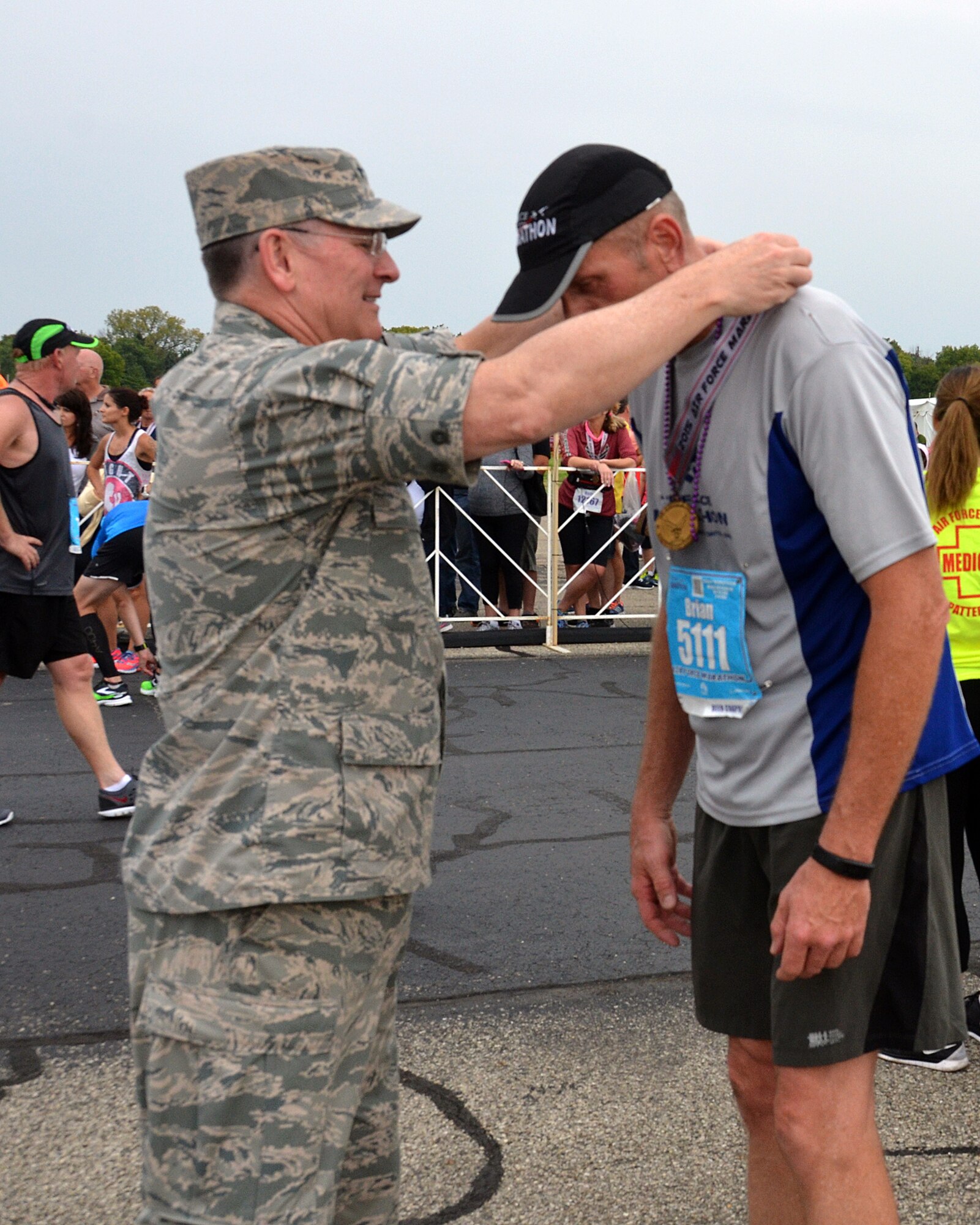 WRIGHT-PATTERSON AIR FORCE BASE, Ohio – Lt. Gen. James F. Jackson, the commander of the AFRC, awards a medal to Chief Master Sgt. Brian Fowle, 445th Aeromedical Evacuation Squadron operations flight chief, after he crossed the finish line in the 19th Annual Air Force Marathon held Sept. 19, 2015. Fowle’s time was 1:59:52. (U.S. Air Force photo/Lt. Col. Cynthia Harris)