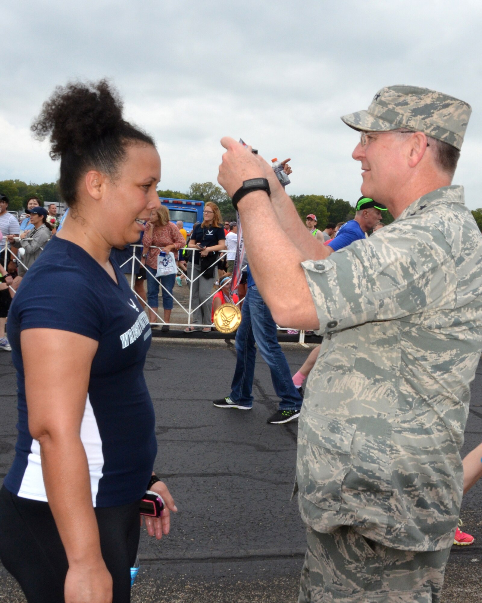 WRIGHT-PATTERSON AIR FORCE BASE, Ohio – Lt. Gen. James F. Jackson, the commander of the AFRC, awards a medal to Master Sgt. Carie Brown, 445th Aeromedical Evacuation Squadron clinical management flight superintendent, after she crossed the finish line in the 19th Annual Air Force Marathon held Sept. 19, 2015. Brown’s time was 2:59:44. (U.S. Air Force photo/Lt. Col. Cynthia Harris)