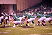 The University of North Dakota football team runs a play against the University of California, Davis at the UND Military Appreciation Day event Sept. 26, 2015 in Grand Forks, North Dakota. Guests were treated to a tailgate party ahead of the game, and military members were offered free tickets to see the matchup. (U.S. Air Force photo/Staff Sgt. Susan L. Davis)