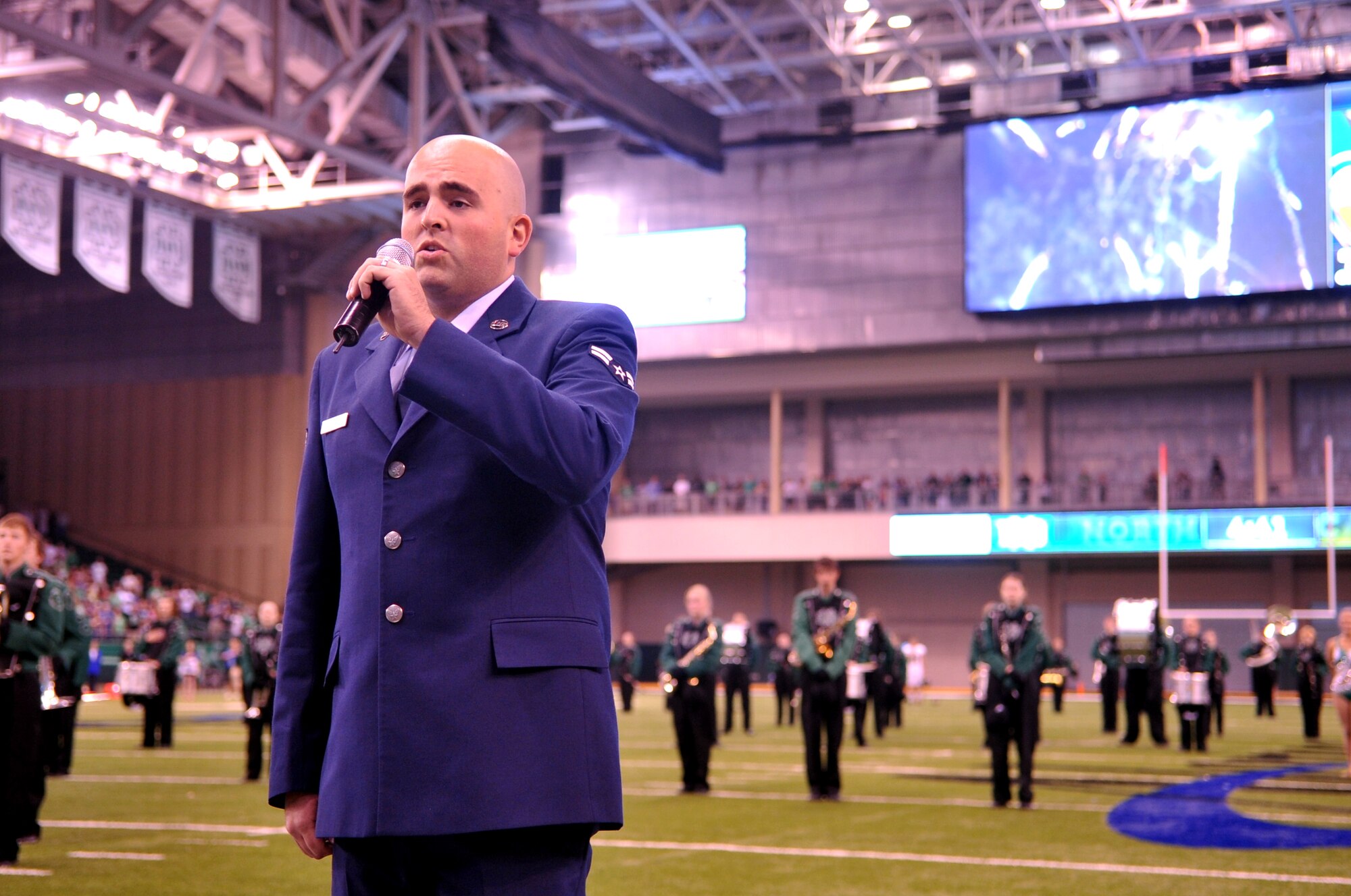 Airman 1st Class Ryan Sparks, 319th Air Base Wing Public Affairs photojournalist, performs the National Anthem at the UND Military Appreciation event Sept. 26, 2015 in Grand Forks, North Dakota. Guests were treated to a tailgate party ahead of the matchup between the University of North Dakota and the University of California, Davis. (U.S. Air Force photo/Staff Sgt. Susan L. Davis)