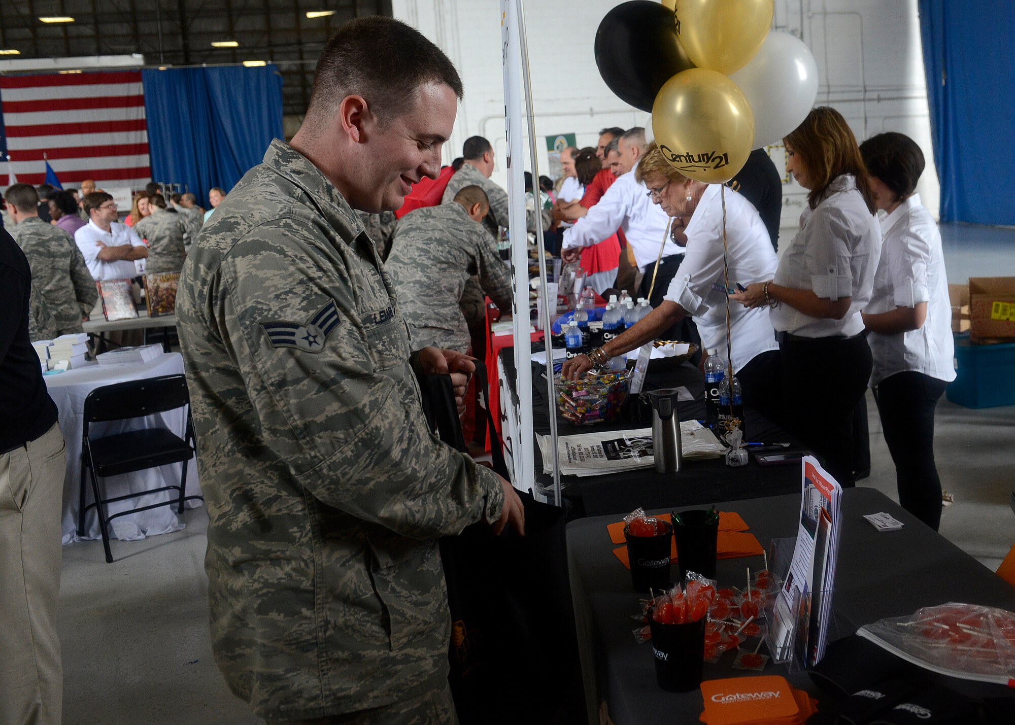 Senior Airman Matthew Lemmer, 20th Communication Squadron radio frequency transmission system technician, visits a booth during the 7th Annual Military Appreciation Picnic at Shaw Air Force Base, S.C., Sept. 25, 2015. Various community businesses came out to show their support and provide information about their businesses throughout the event. (U.S. Air Force photo by Airman 1st Class Christopher Maldonado/Released)
