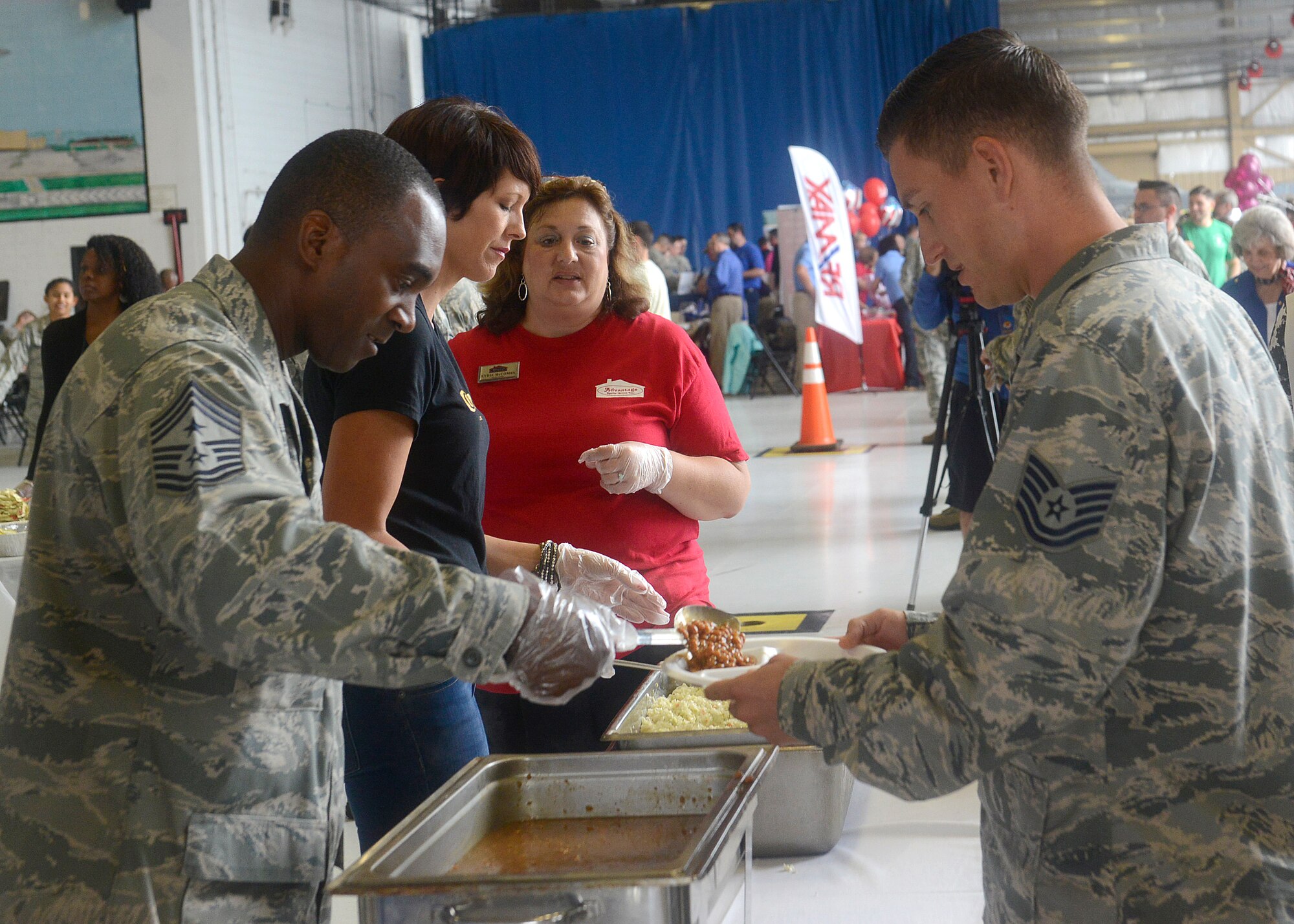 U.S. Air Force Chief Master Sgt. Christopher McKinney 20th Fighter Wing command chief, serves food to Airmen during the 7th Annual Military Appreciation Picnic at Shaw Air Force Base, S.C., Sept. 25, 2015. McKinney came out to show his support for the Airmen and the community whose businesses have made a presence here. (U.S. Air Force photo by Airman 1st Class Christopher Maldonado/Released)