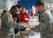 U.S. Air Force Chief Master Sgt. Christopher McKinney 20th Fighter Wing command chief, serves food to Airmen during the 7th Annual Military Appreciation Picnic at Shaw Air Force Base, S.C., Sept. 25, 2015. McKinney came out to show his support for the Airmen and the community whose businesses have made a presence here. (U.S. Air Force photo by Airman 1st Class Christopher Maldonado/Released)