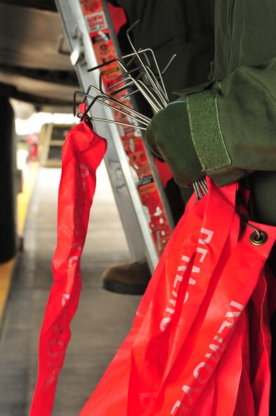 A member of the 69th Bomb Squadron holds pins from bombs at Minot Air Force Base, N.D., Sept. 23, 2015. All pins must be removed from the ordnance before flight so that the bombs can properly deploy once the crew is airborne. (U.S. Air Force photo/Senior Airman Stephanie Morris)