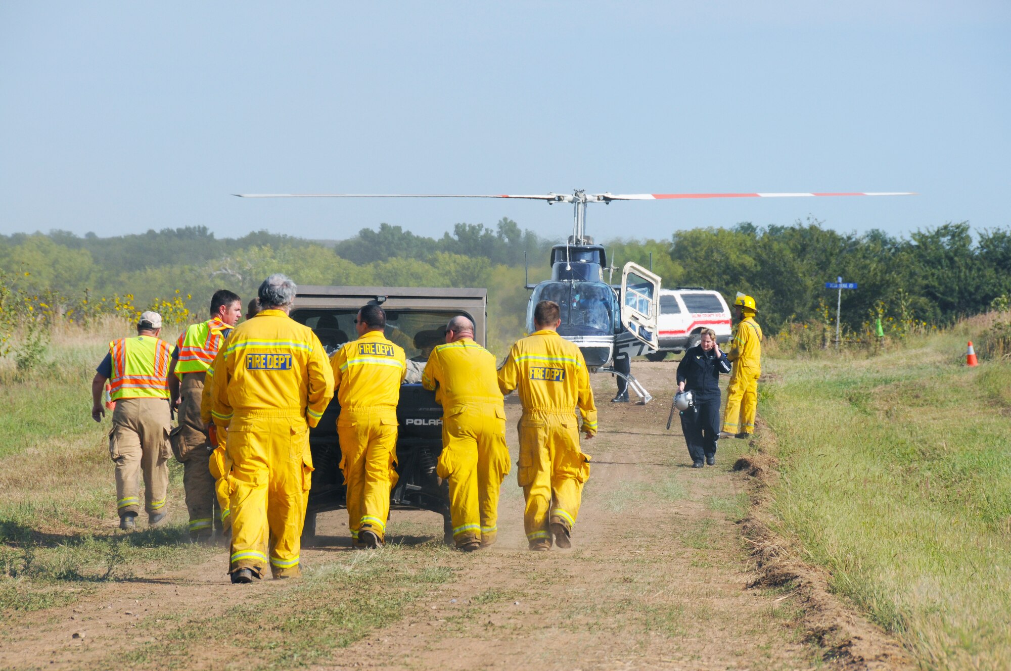 Rescue personnel, including Saline County Sheriff officers and local firefighters, transport a wounded Airman to a medical helicopter during an exercise called “Herc Down,” hosted by Detachment 1, Smoky Hill Weapons Range Sept. 12. (Photo by Master Sgt. Matt McCoy, 184th Public Affairs)