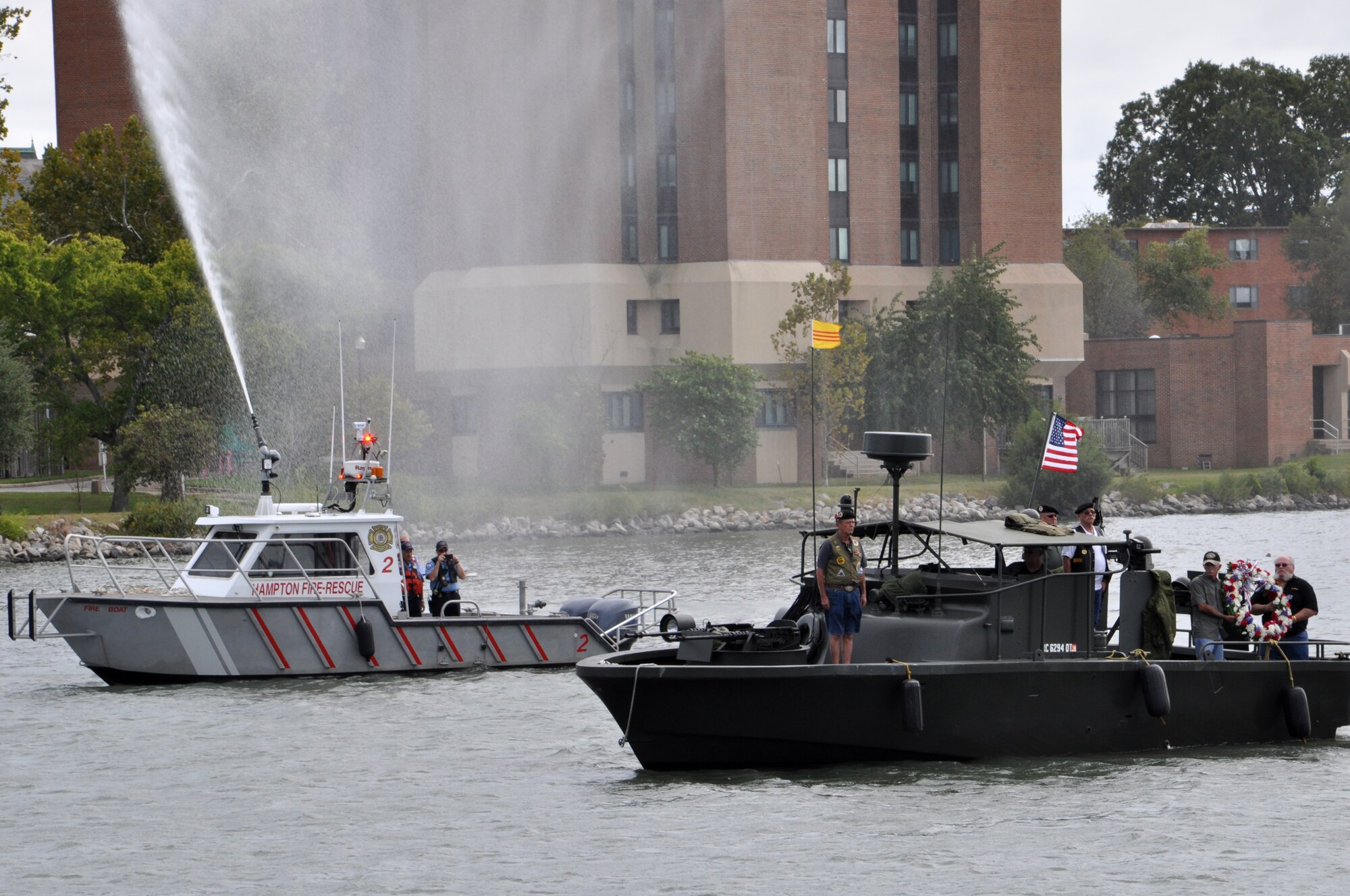 Veterans of the U.S. Navy Riverine Operations in Vietnam escort a memorial wreath during the 458th Sea Tigers 2015 Reunion Memorial ceremony at the Hampton Maritime Center in Hampton Va., Sept. 24, 2015. The wreath was laid on the Hampton River in memory of Pfc. Michael Glenn Loyd who died during the Vietnam War forty-six years ago. (U.S. Air Force photo by Master Sgt. April Wickes/Released)