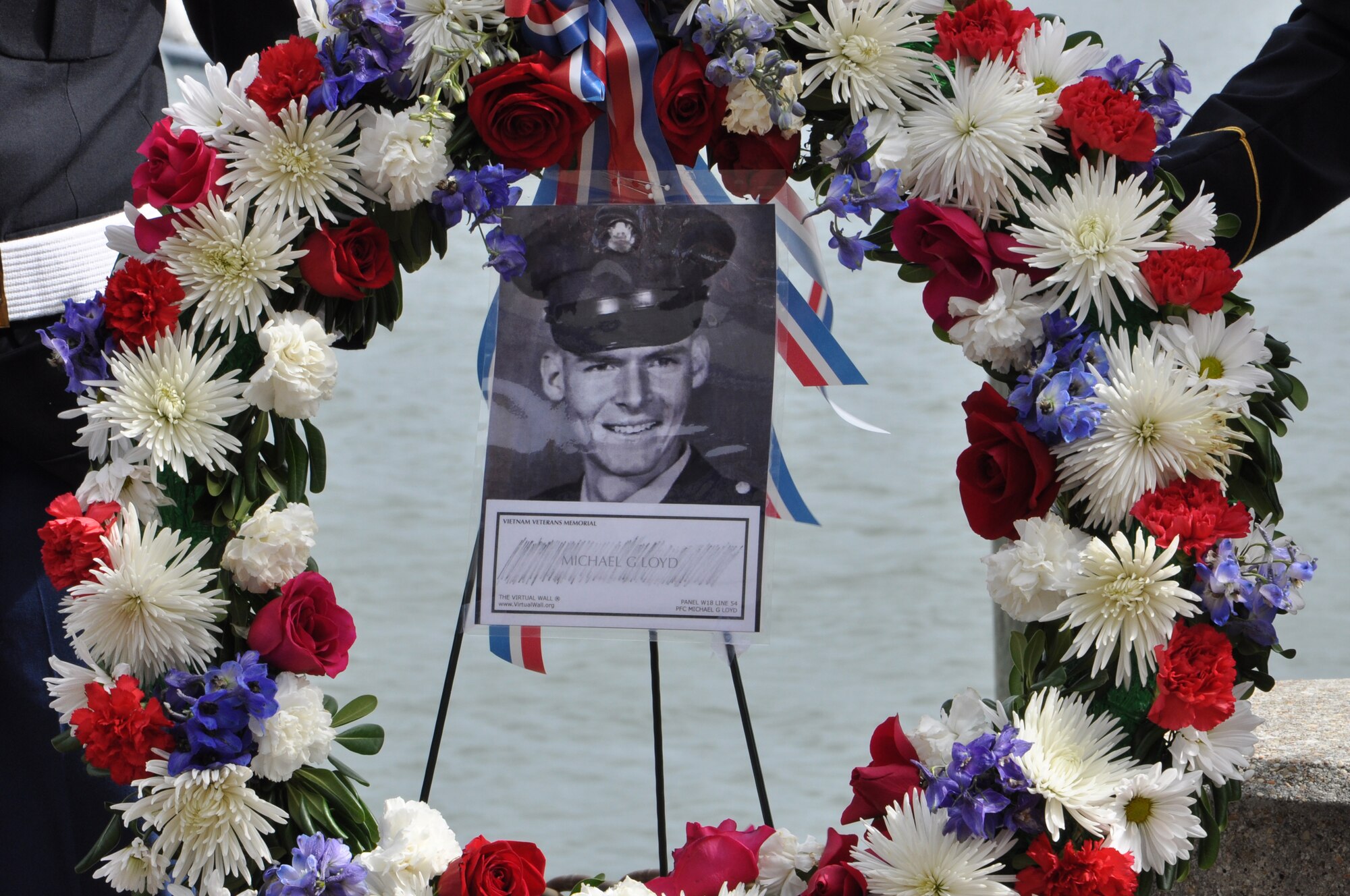 An image of U.S. Army Pfc. Michael Glenn Loyd is displayed on a wreath during the 458th Sea Tigers 2015 Reunion Memorial ceremony at the Hampton Maritime Center in Hampton, Va., Sept. 24, 2015. The wreath was carried away on a river patrol boat and laid on the Hampton River in memory of Loyd. (U.S. Air Force photo by Master Sgt. April Wickes/Released)