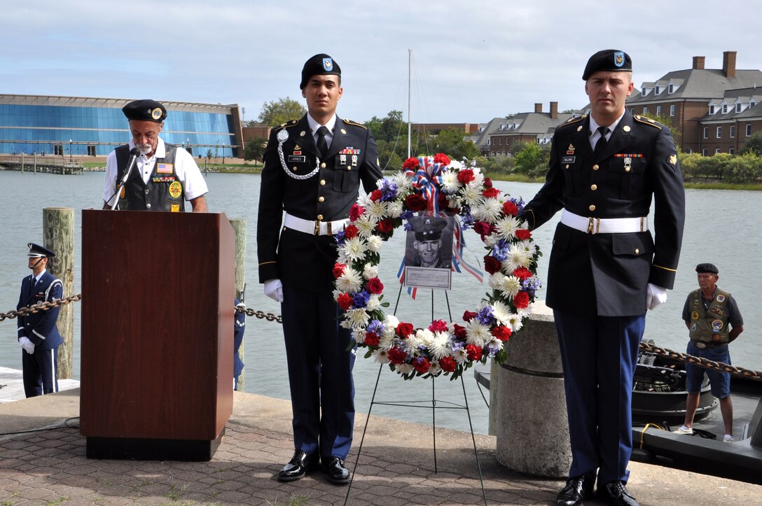 U.S. Army Spcs. Christopher Jones and Taylor Williams, 7th Sustainment Brigade Expeditionary, 53rd Movement Control Battalion, 567th Inland Cargo Transfer Company, ceremony wreath bearers hold the wreath during the 458th Sea Tigers 2015 Reunion Memorial ceremony at the Hampton Maritime Center in Hampton, Va., Sept. 24, 2015.  The ceremony was held to honor Pfc. Michael Glenn Loyd who died during the Vietnam Conflict 46 years ago. (U.S. Air Force photo by Master Sgt. April Wickes/Released) 
