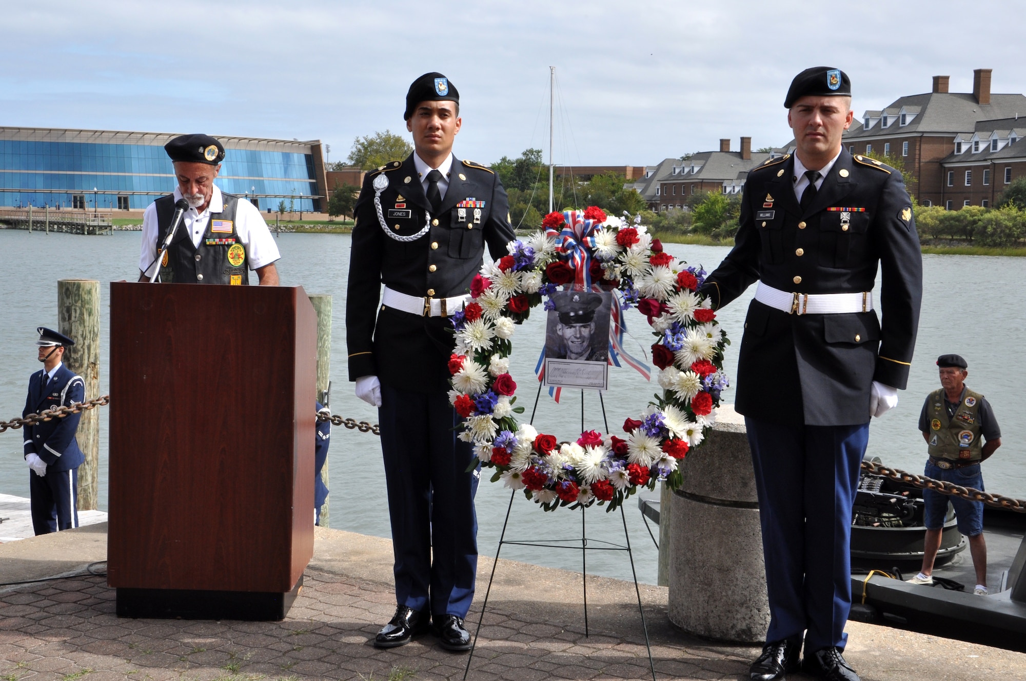 U.S. Army Spcs. Christopher Jones and Taylor Williams, 7th Sustainment Brigade Expeditionary, 53rd Movement Control Battalion, 567th Inland Cargo Transfer Company, ceremony wreath bearers hold the wreath during the 458th Sea Tigers 2015 Reunion Memorial ceremony at the Hampton Maritime Center in Hampton, Va., Sept. 24, 2015.  The ceremony was held to honor Pfc. Michael Glenn Loyd who died during the Vietnam Conflict 46 years ago. (U.S. Air Force photo by Master Sgt. April Wickes/Released) 