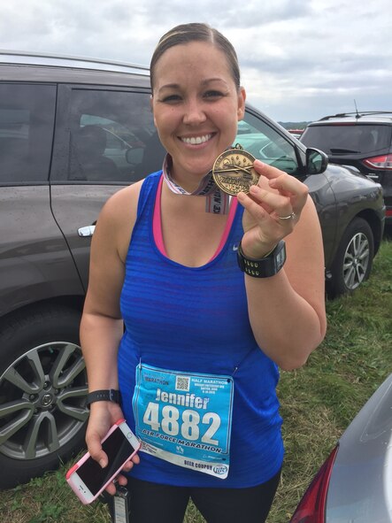 Tech. Sgt. Jennifer Emerson, 50th Space Wing executive assistant to the command chief, shows off her medal after completing the Air Force half marathon Sept. 19, 2015, at Wright-Patterson Air Force Base, Ohio. Emerson finished with a time of 2:35:45. (Courtesy photo)