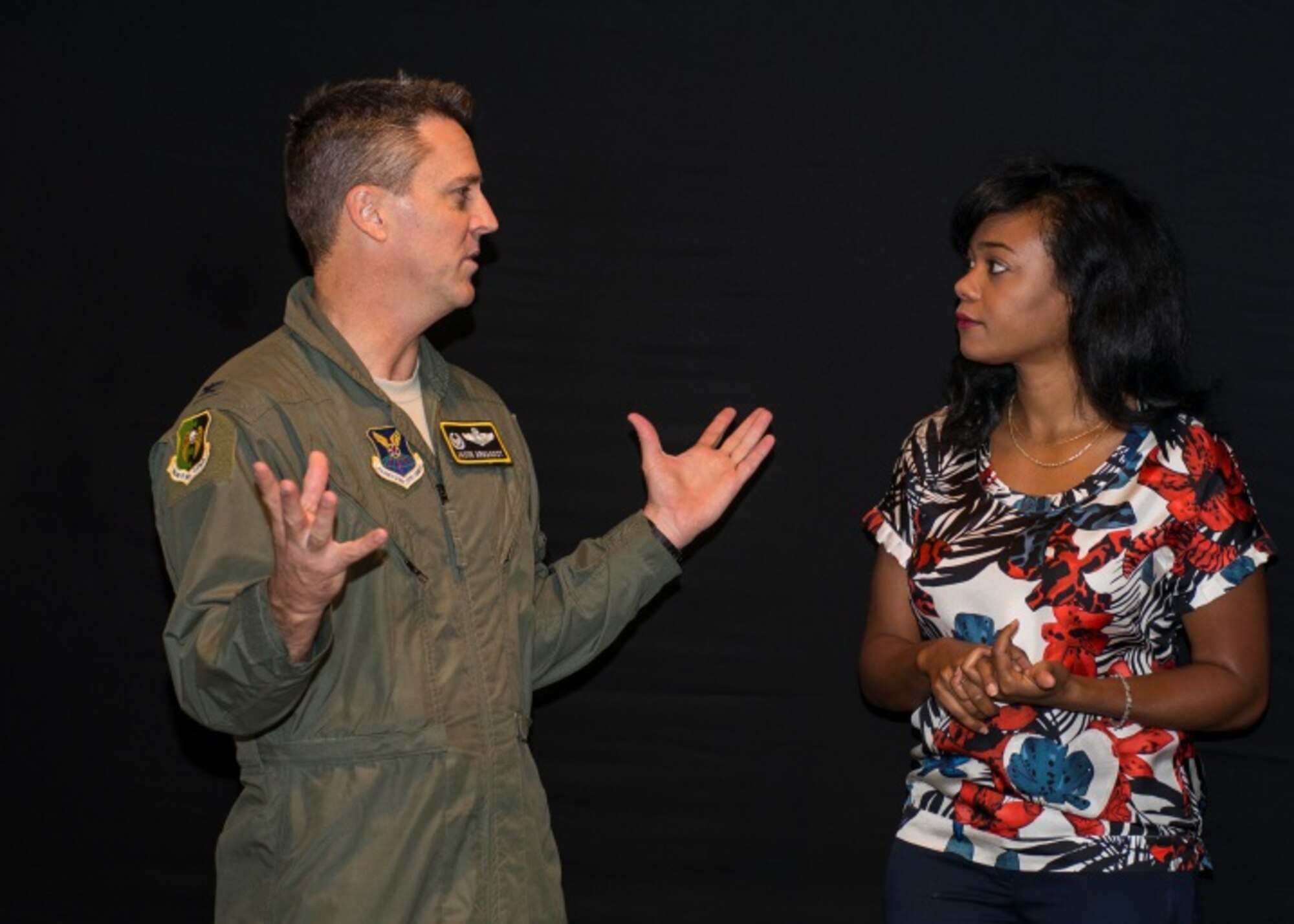 Tatyana Ali, actress, listens to Col. Jason Armagost, 5th Bomb Wing commander, at the Jimmy Doolittle Center at Minot Air Force Base, N.D, September 21, 2015. Ali is a Harvard graduate and spoke to Airmen about her own struggles to reach goals, including her struggle with depression in college. (U.S. Air Force photo/Airman 1st Class Justin T. Armstrong)