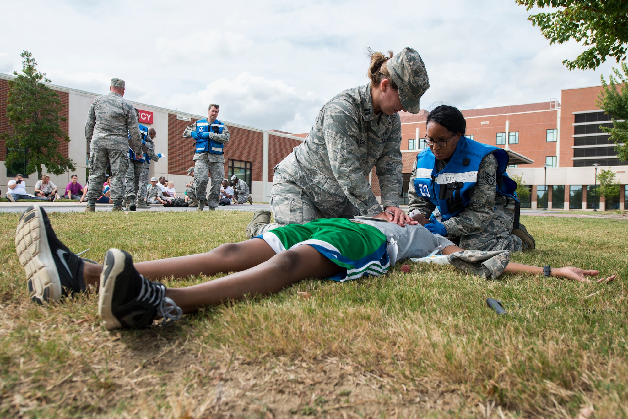 U.S. Air Force medical personnel provide emergency treatment to a simulated injured patient during a mass casualty exercise at Langley Air Force Base, Va., Sept. 24, 2015. The exercise prepared Airmen for disasters and deployments. (U.S. Air Force photo by Senior Airman Kayla Newman/Released)