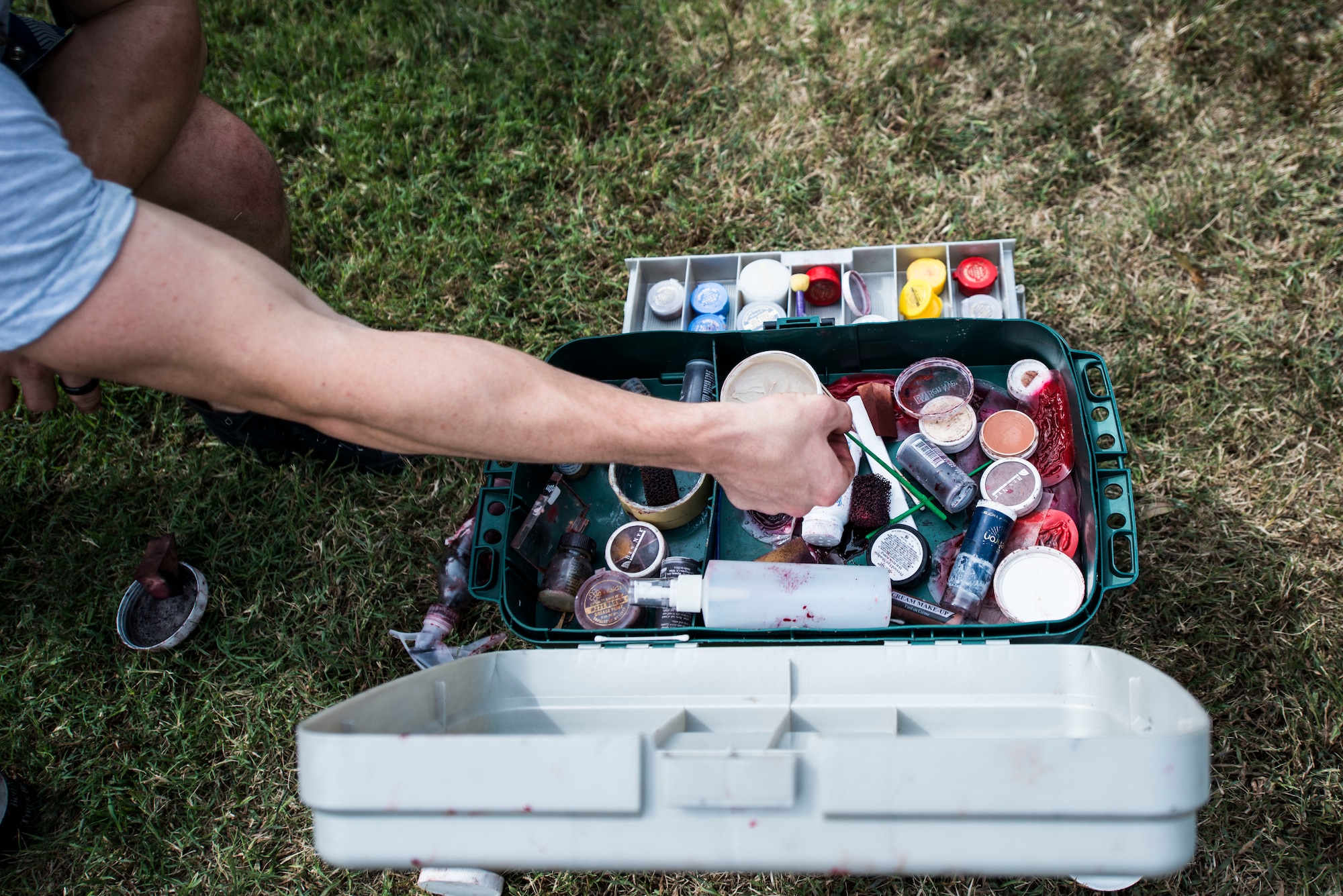 A U.S. Air Force Airman reaches for moulage equipment prior to a mass casualty exercise at Langley Air Force Base, Va., Sept. 24, 2015. Air Force personnel use exercises to test all aspects of disaster team and medical contingency response plans in the event of real-world emergencies. (U.S. Air Force photo by Senior Airman Kayla Newman/Released)