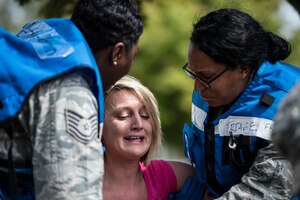U.S. Air Force medical personnel help a simulated injured woman during a mass casualty exercise at Langley Air Force Base, Va., Sept. 24, 2015. The exercise was designed to increase the capabilities of medical personnel during disaster and wartime emergencies. (U.S. Air Force photo by Senior Airman Kayla Newman/Released)