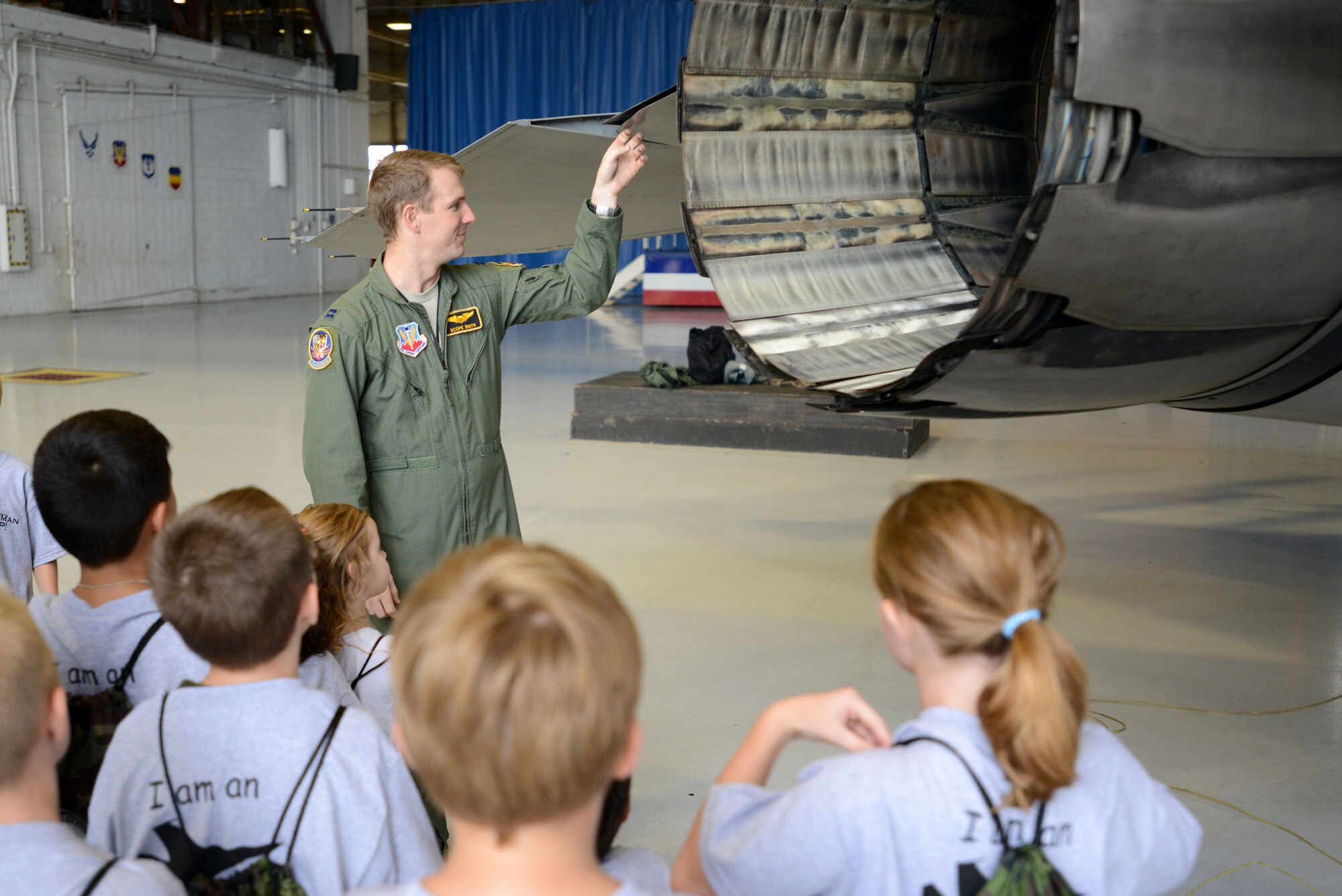 U.S. Air Force Capt. Kirk Smith, 79th Fighter Squadron pilot, explains the functions of different parts of an F-16CM Fighting Falcon to a crowd of children during the Kids Meet the Viper event at Shaw Air Force Base, S.C., Sept. 23, 2015. The event was held to educate military children about deployments and what their parents may experience when they have to leave home. (U.S. Air Force photo by Airman 1st Class Kelsey Tucker/Released)