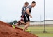 U.S. Air Force Airmen run down a dirt hill during a 20th Fighter Wing Comprehensive Airman Fitness week obstacle course at Shaw Air Force Base, S.C., Sept. 25, 2015. The Airmen participated in varying obstacles throughout the run to test their endurance and resiliency to changing conditions. (U.S. Air Force photo by Airman 1st Class Christopher Maldonado/Released)