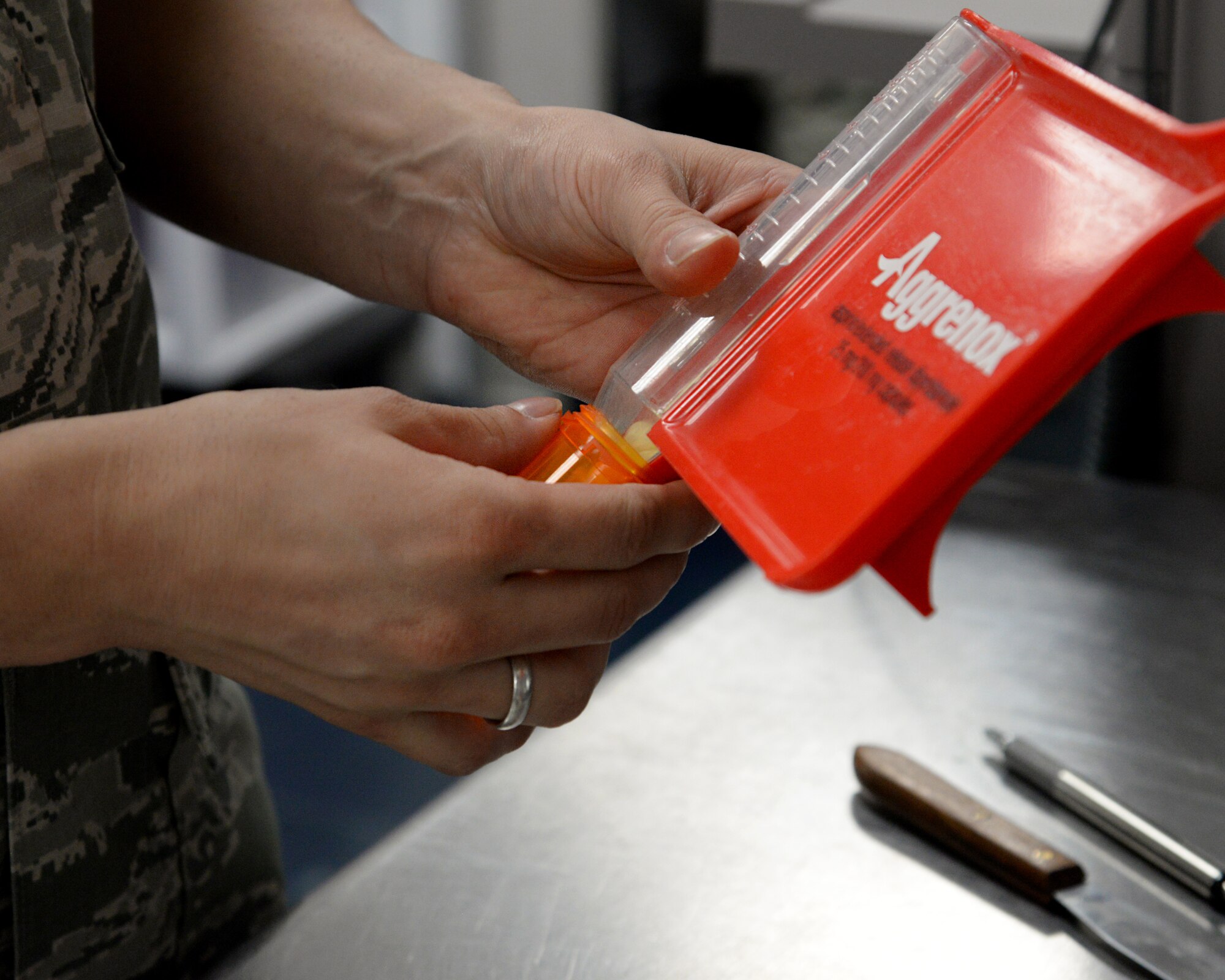 Airman 1st Class Cameran Vincent, 2nd Medical Support Squadron narcotics custodian, fills a prescription at Barksdale Air Force Base, La., Sept. 24, 2015. Before filling a bottle, technicians count each tablet to ensure patients receive the correct amount medical providers prescribed. (U.S. Air Force photo/Senior Airman Jannelle Dickey)