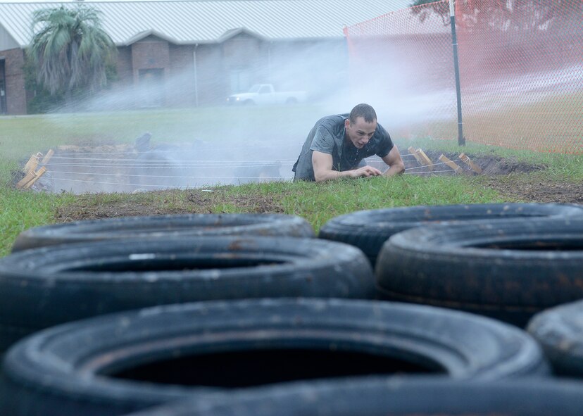 U.S. Air Force Airmen participate in ball-bounce obstacle during a 20th Fighter Wing Comprehensive Airman Fitness week obstacle course at Shaw Air Force Base, S.C., Sept. 25, 2015.  The various obstacles in the event were meant to test the physical domain of Airmen fitness. (U.S. Air Force photo by Airman 1st Class Christopher Maldonado/Released)