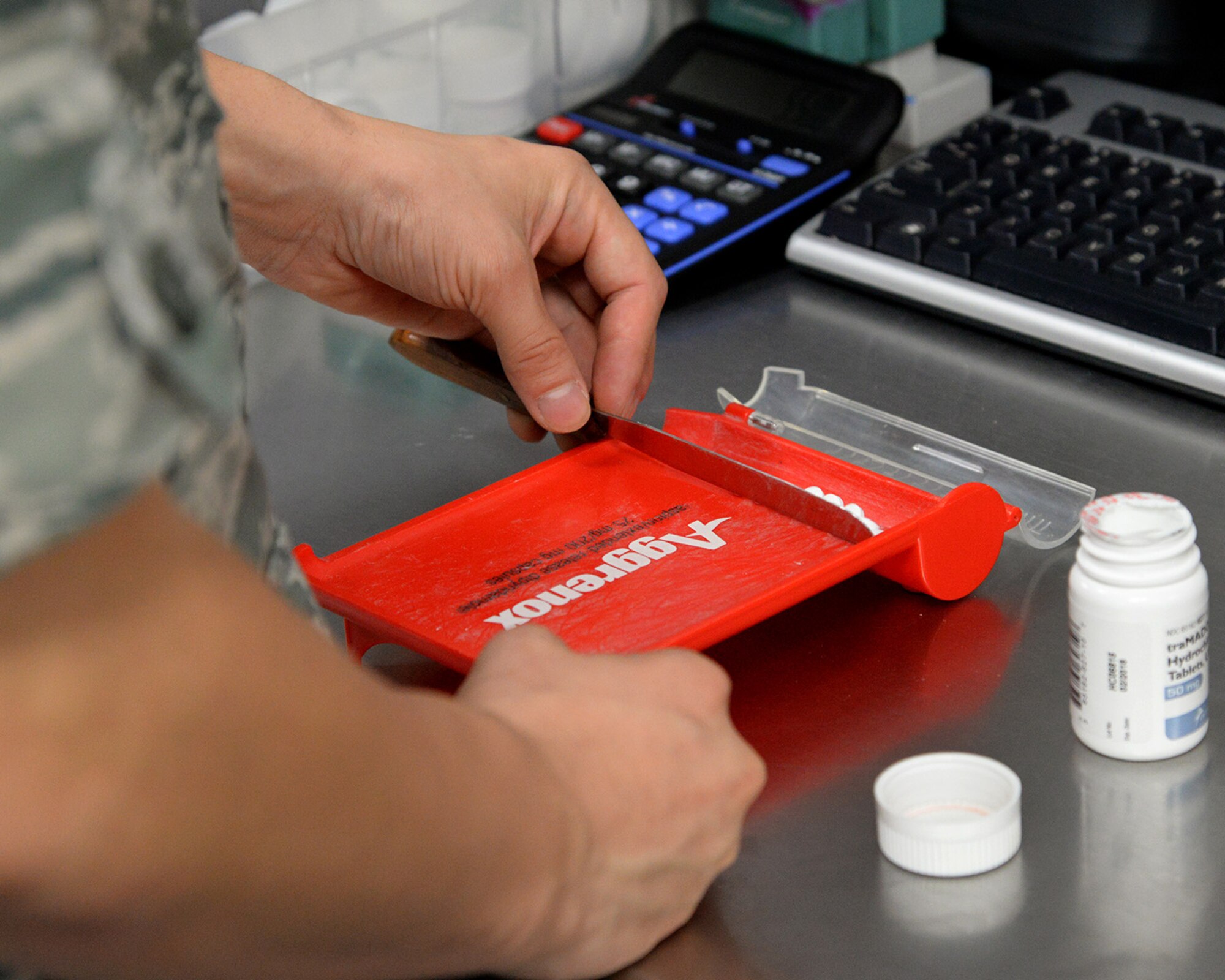 Airman 1st Class Cameran Vincent, 2nd Medical Support Squadron narcotics custodian, counts controlled narcotics at Barksdale Air Force Base, La., Sept. 24, 2015. This procedure is required to ensure the patient receives the correct prescription count and the stock remains accurate. (U.S. Air Force photo/Senior Airman Jannelle Dickey)
