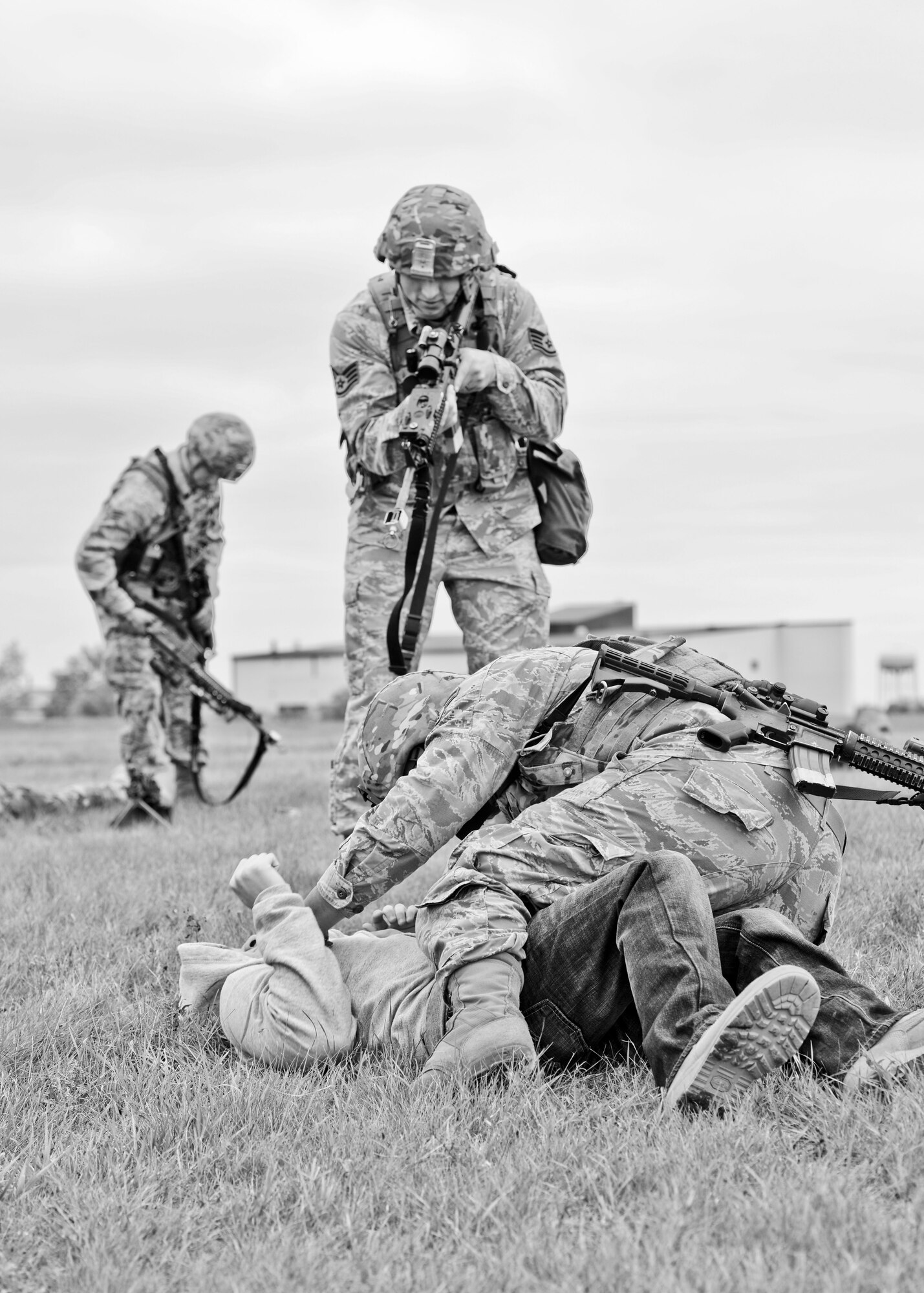 Airmen from the 5th Security Forces Squadron detain and search an Airman role playing as an oppositional force during a training exercise on the hot cargo pad at Minot Air Force Base, N.D., September 24, 2015.  Nine Airmen from the 5th SFS played the role of an oppositional force attempting to overtake the convoy at the cargo pad. (U.S. Air Force photo/Airman 1st Class Justin T. Armstrong)
