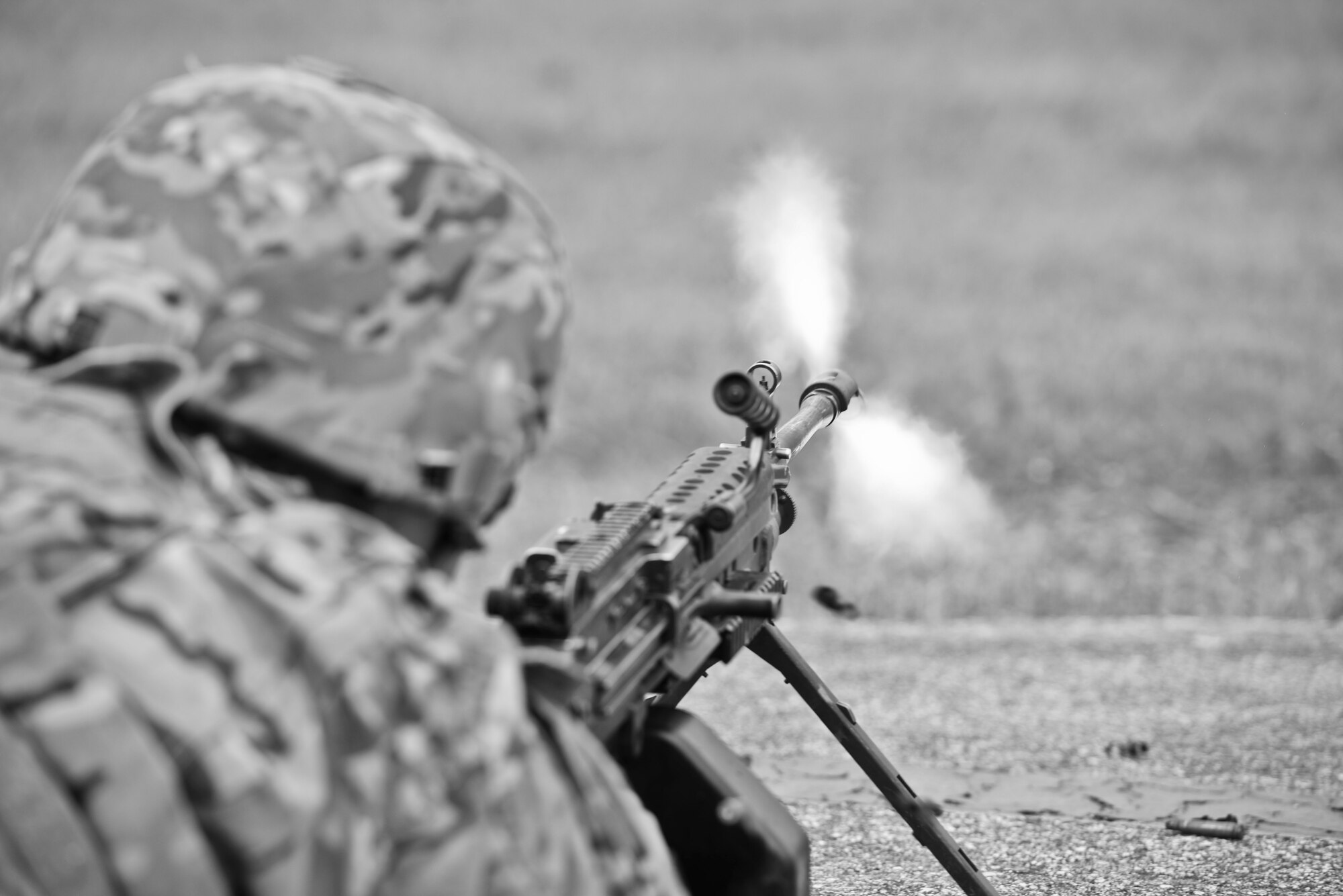 An Airman from the 5th Security Forces Squadron fires a M249 during a training exercise on the hot cargo pad at Minot Air Force Base, N.D., September 24, 2015.  The force-on-force exercise lasted approximately two hours and simulated the protection of nuclear equipment. (U.S. Air Force photo/Airman 1st Class Justin T. Armstrong)
