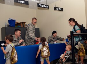 Team McConnell family members go through a simulated deployment line, Sept. 26, 2015, at McConnell Air Force Base, Kan. The families went through the pre-deployment process, including receiving simulation shots from medical, combat arms training and maintenance training. (U.S. Air Force photo by Senior Airman Colby L. Hardin)